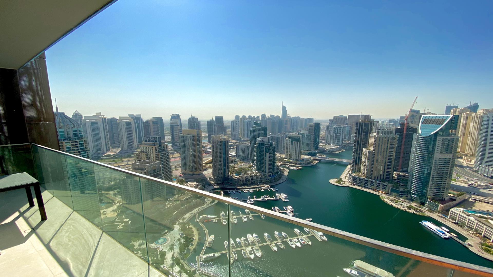"Modern 1-bedroom apartment with marina view, open-plan living, dining in Dubai Marina.",Dubai Marina apartment balcony view of marina and skyline, Marina Gate community, for rent
