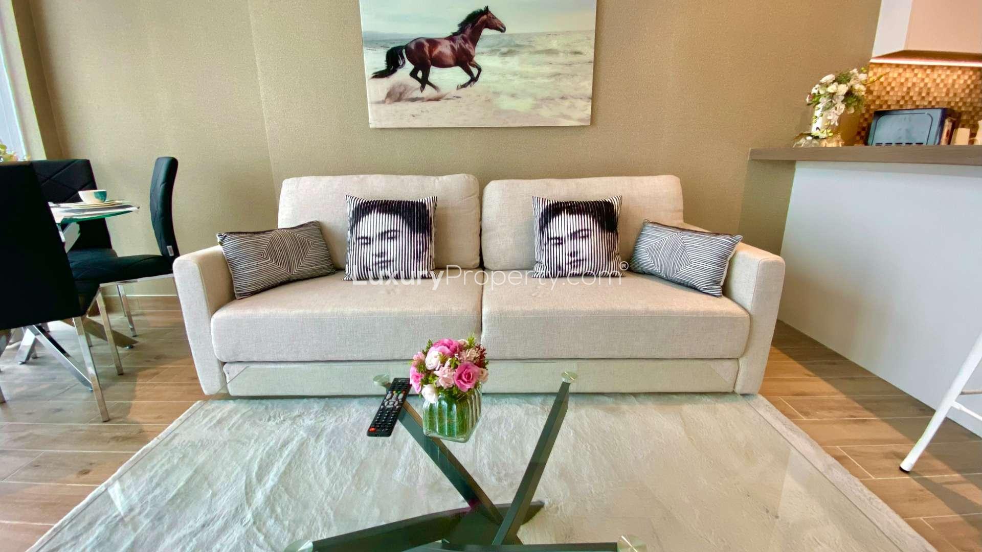 Modern living area in Dubai Marina apartment, featuring stylish decor and open-plan kitchen