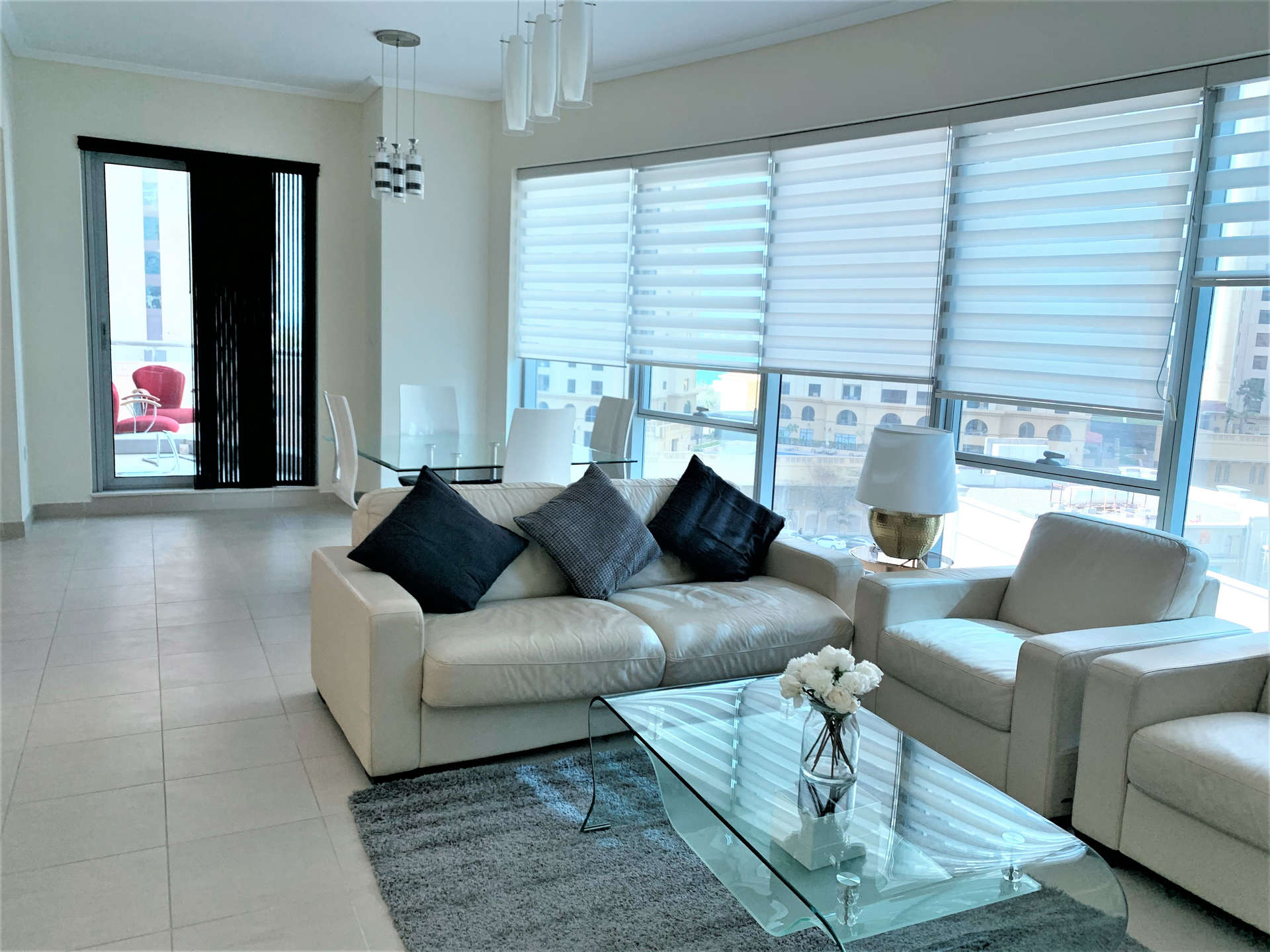 "Modern high-rise buildings in Marina Promenade, Dubai Marina under clear blue sky.",Modern living room in fully furnished 1-bedroom apartment, Marina Promenade, Dubai Marina
