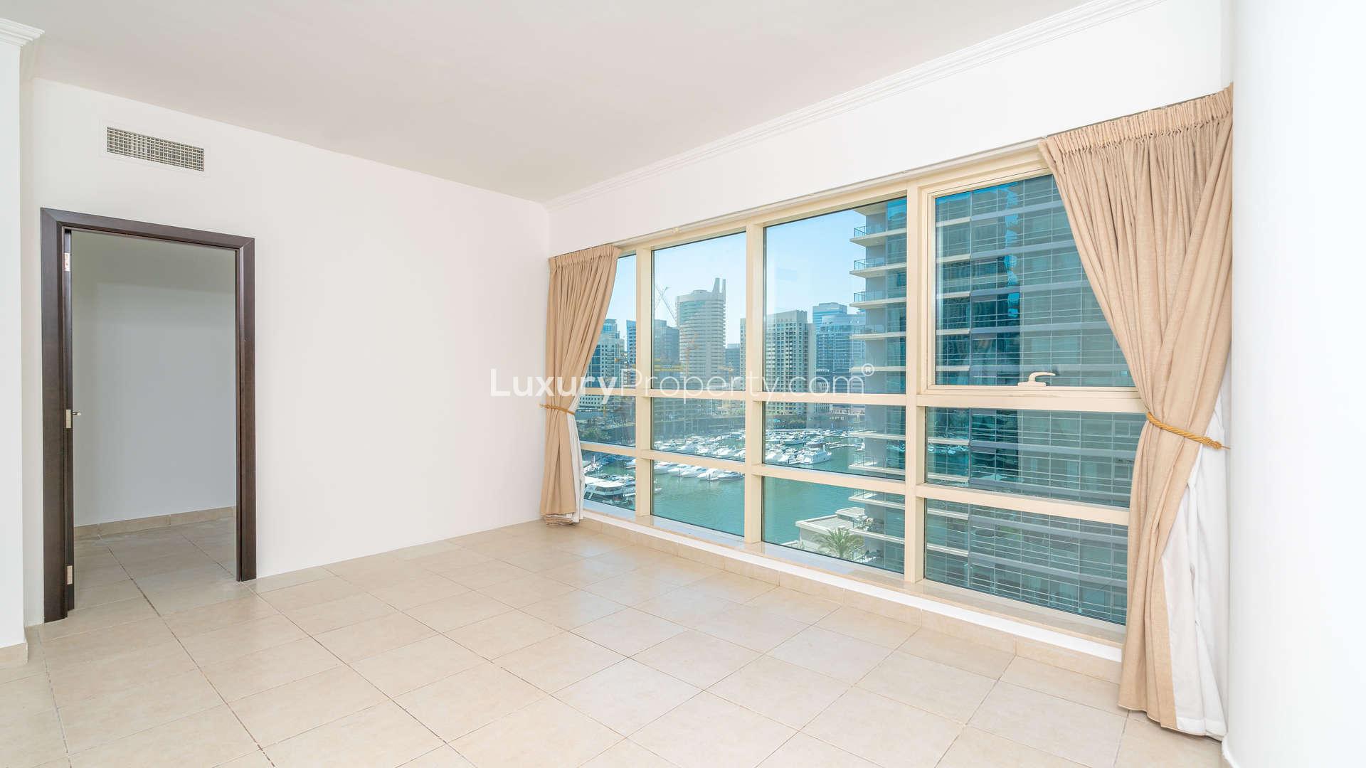 Elegant living room with large windows and balcony view in Marina Quays apartment, Dubai Marina