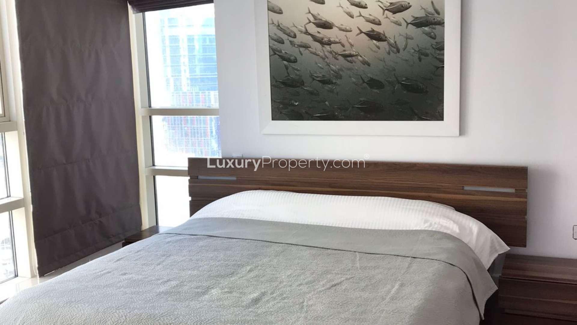 Aerial view of Dubai Marina Quay West with yachts and waterfront buildings, sunny day