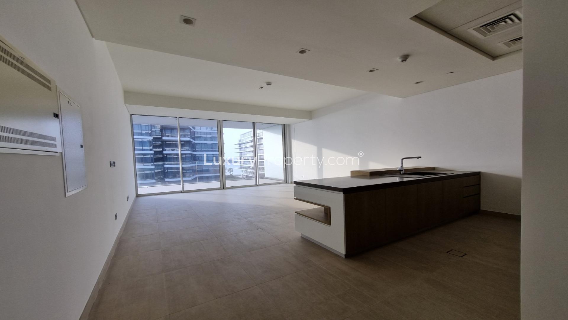 "Modern apartment view at Serenia Residences, Palm Jumeirah, overlooking sea and sunset.",Modern open-plan kitchen and living area in Serenia Residences, Palm Jumeirah apartment for rent