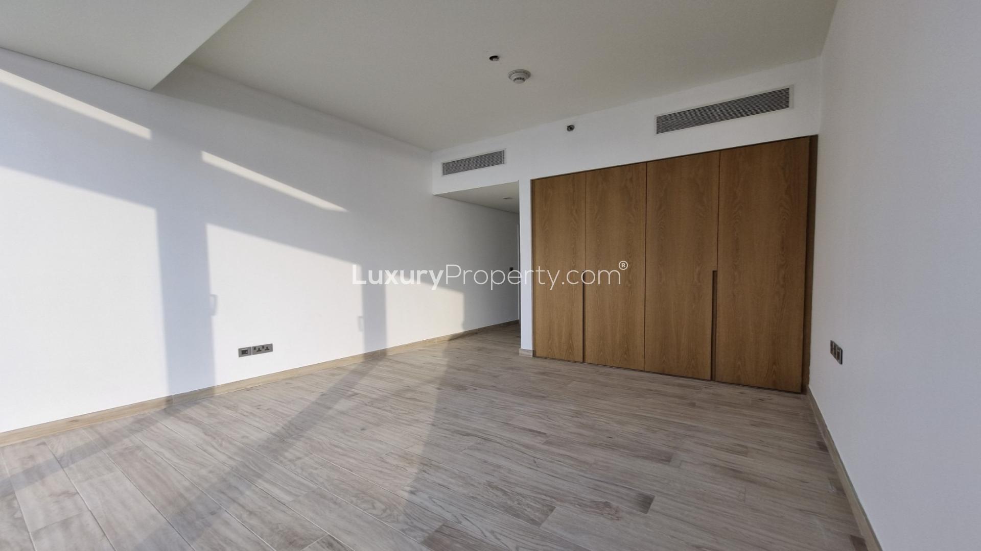 Empty bedroom with wooden floor and built-in wardrobe at Serenia Residences, Palm Jumeirah