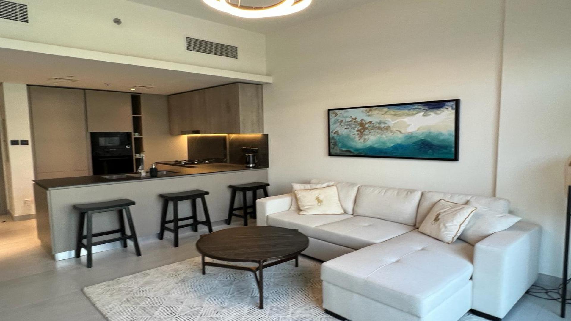 Furnished apartment living area with modern kitchen, Jumeirah Village Circle, Oxford Boulevard