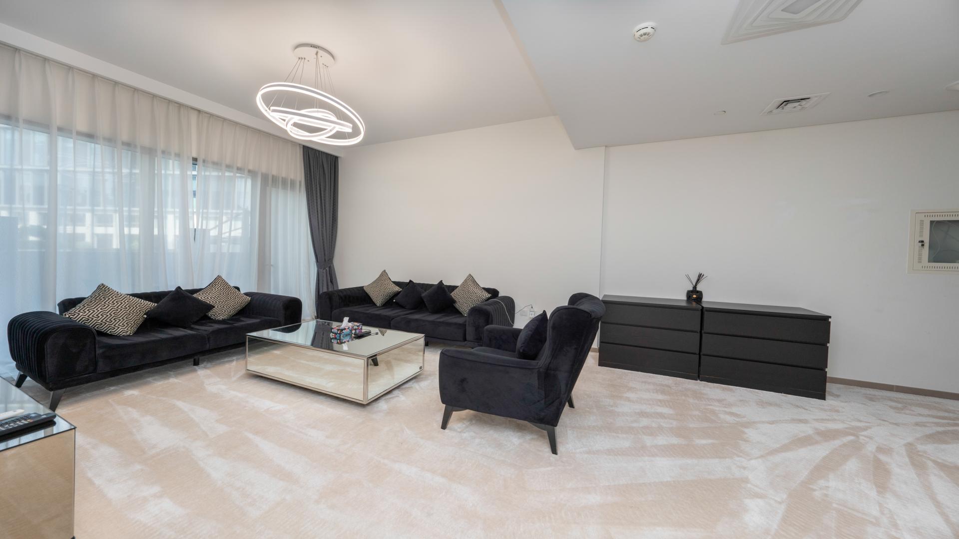 Modern living room in Park Heights apartment, Dubai Hills Estate, with sleek furniture and decor