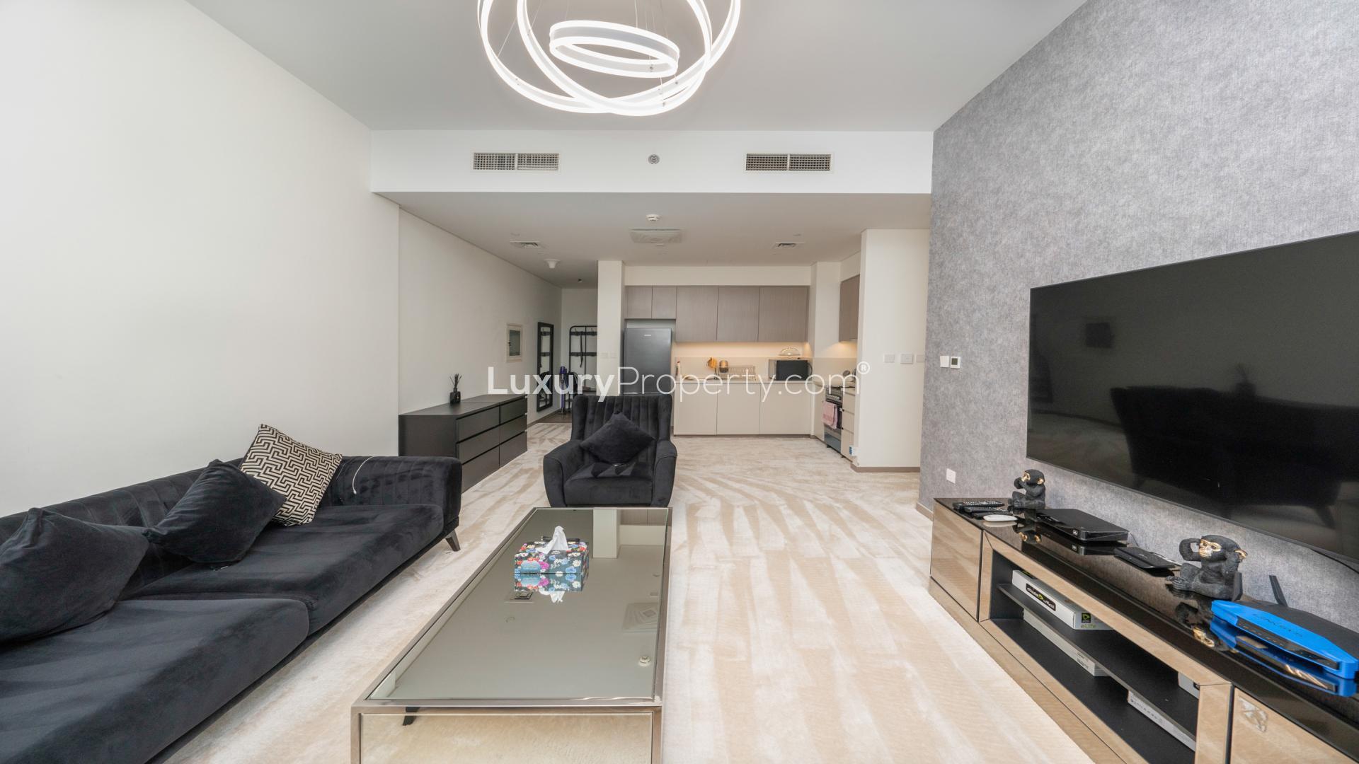 Modern living room in Dubai Hills Estate apartment, featuring elegant furnishings and ample natural light