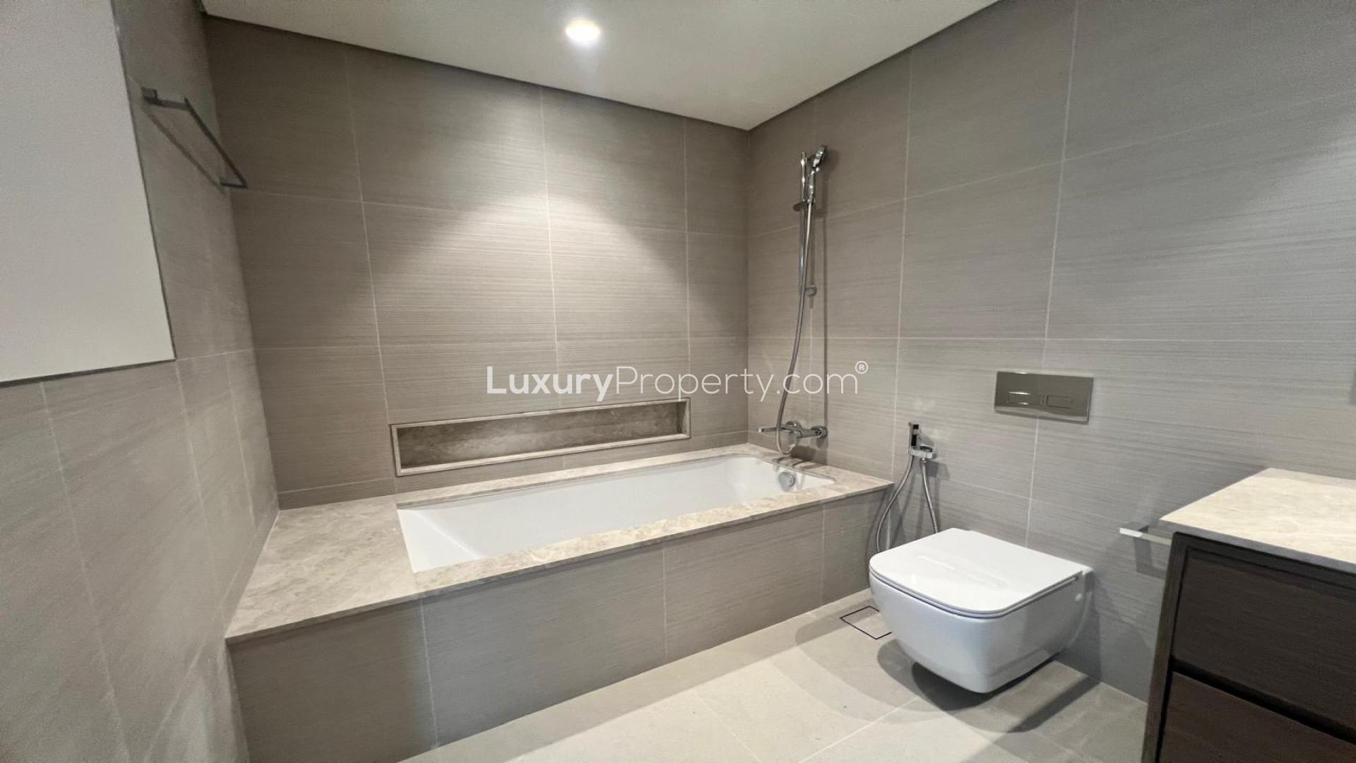 Empty living room with large windows in Downtown Dubai 1-bedroom apartment, Grande Signature Residences