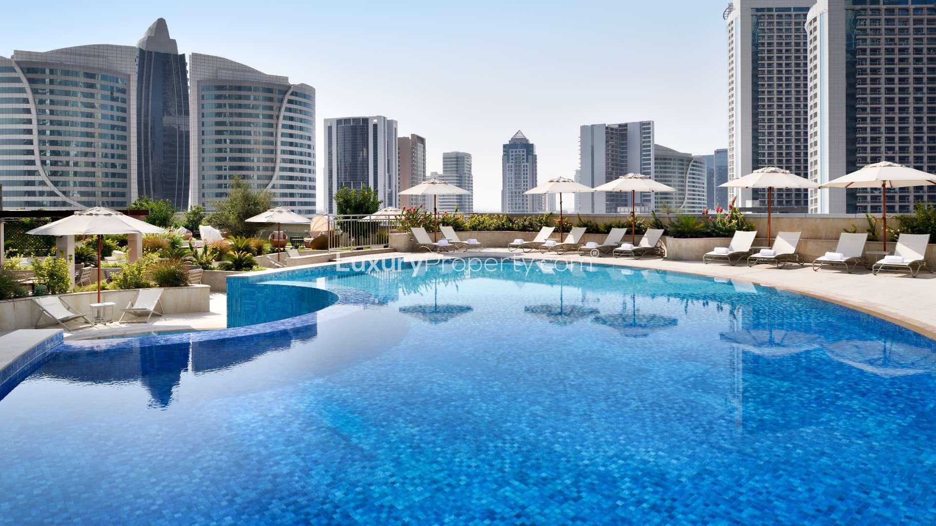 Modern living room and kitchen in 1-bedroom apartment, Downtown Dubai, Movenpick Hotel Apartments