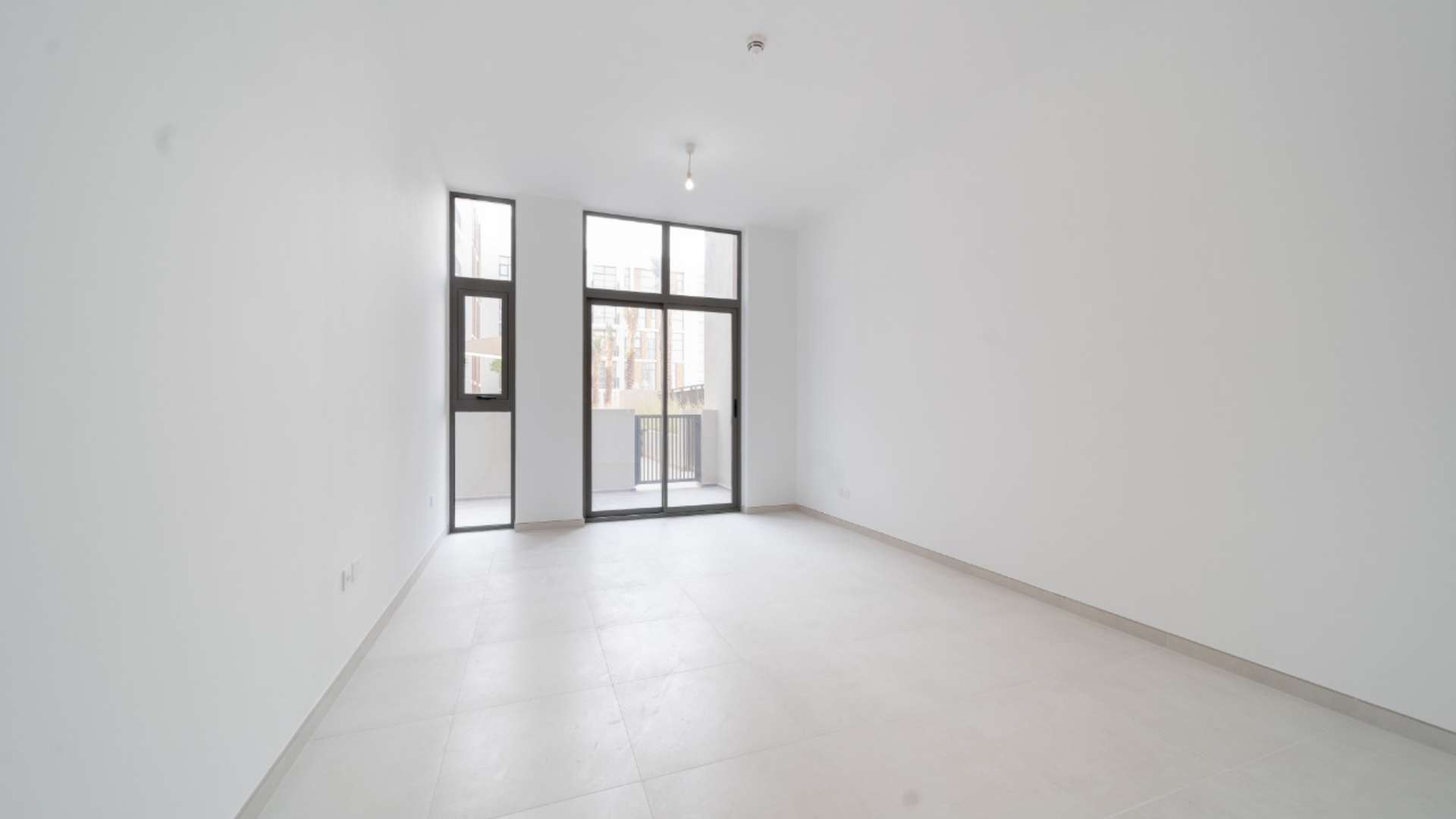 Modern living room in Mudon Views 1-bedroom apartment with open layout and bright interior