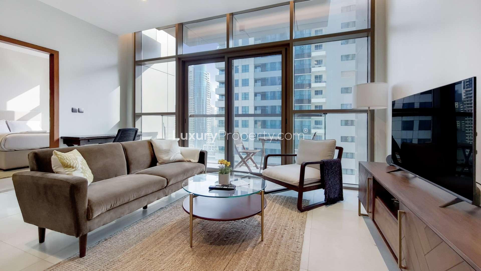 Modern living room in one-bedroom apartment, No.9 Dubai Marina, with balcony view