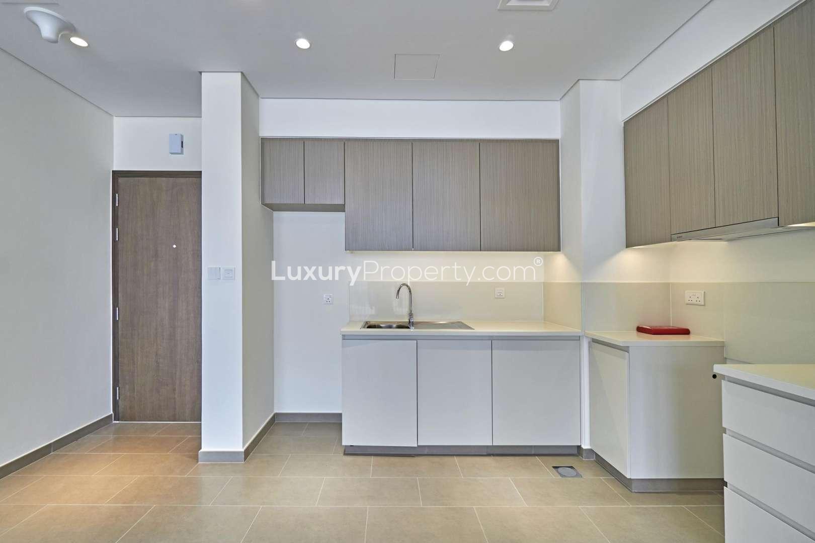 Modern kitchen and living area in Park Heights apartment, Dubai Hills Estate