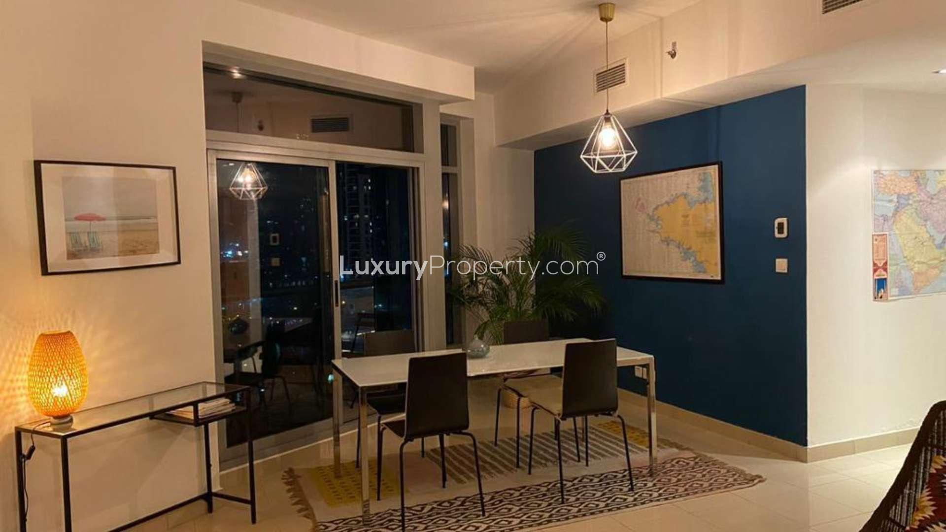 Dining area in spacious Dubai Marina apartment with modern decor and large window view