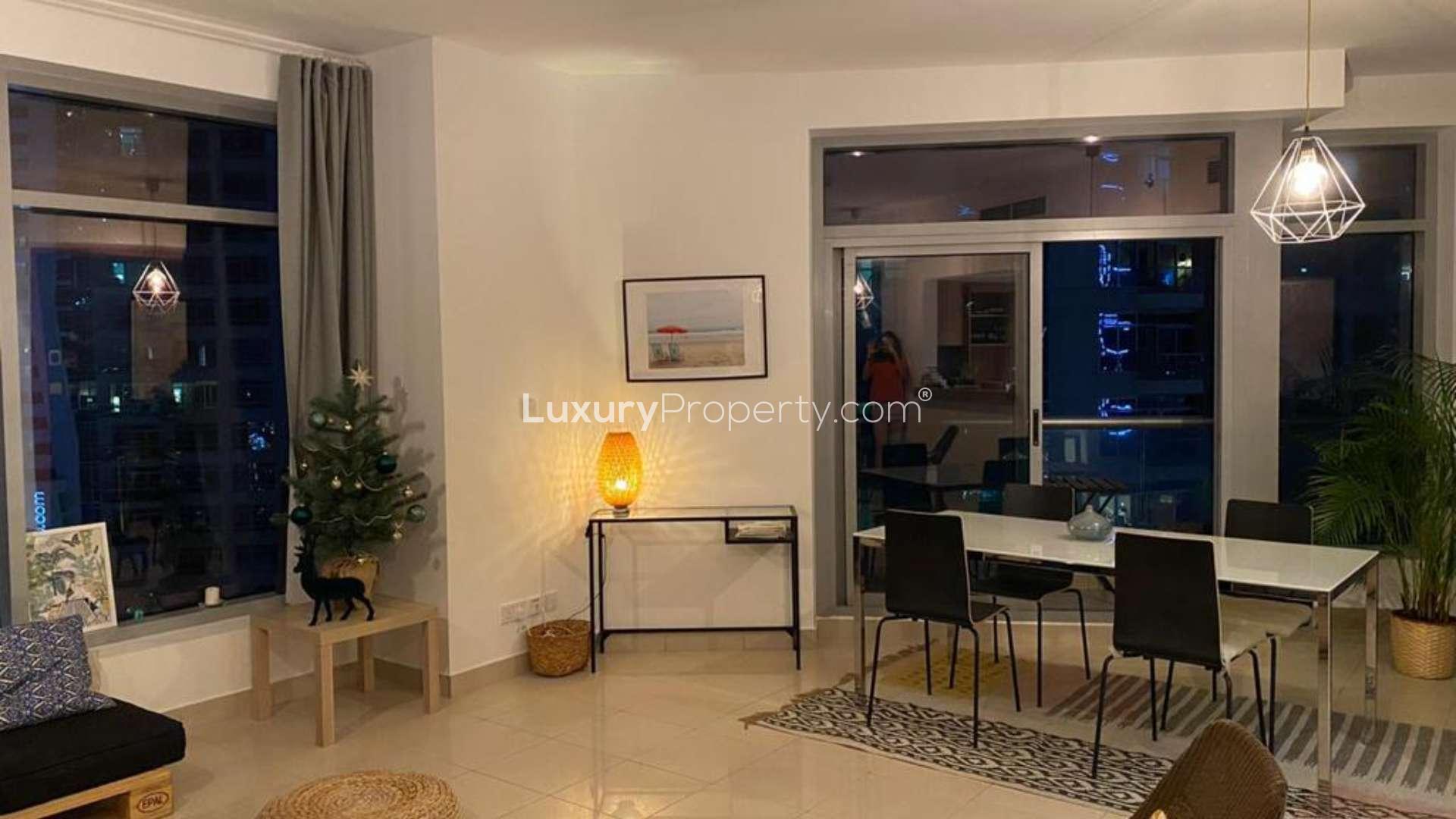 "Night view from Park Island apartment balcony overlooking Dubai Marina skyline and water.",Modern living room in Park Island apartment, Dubai Marina, with elegant decor and large windows