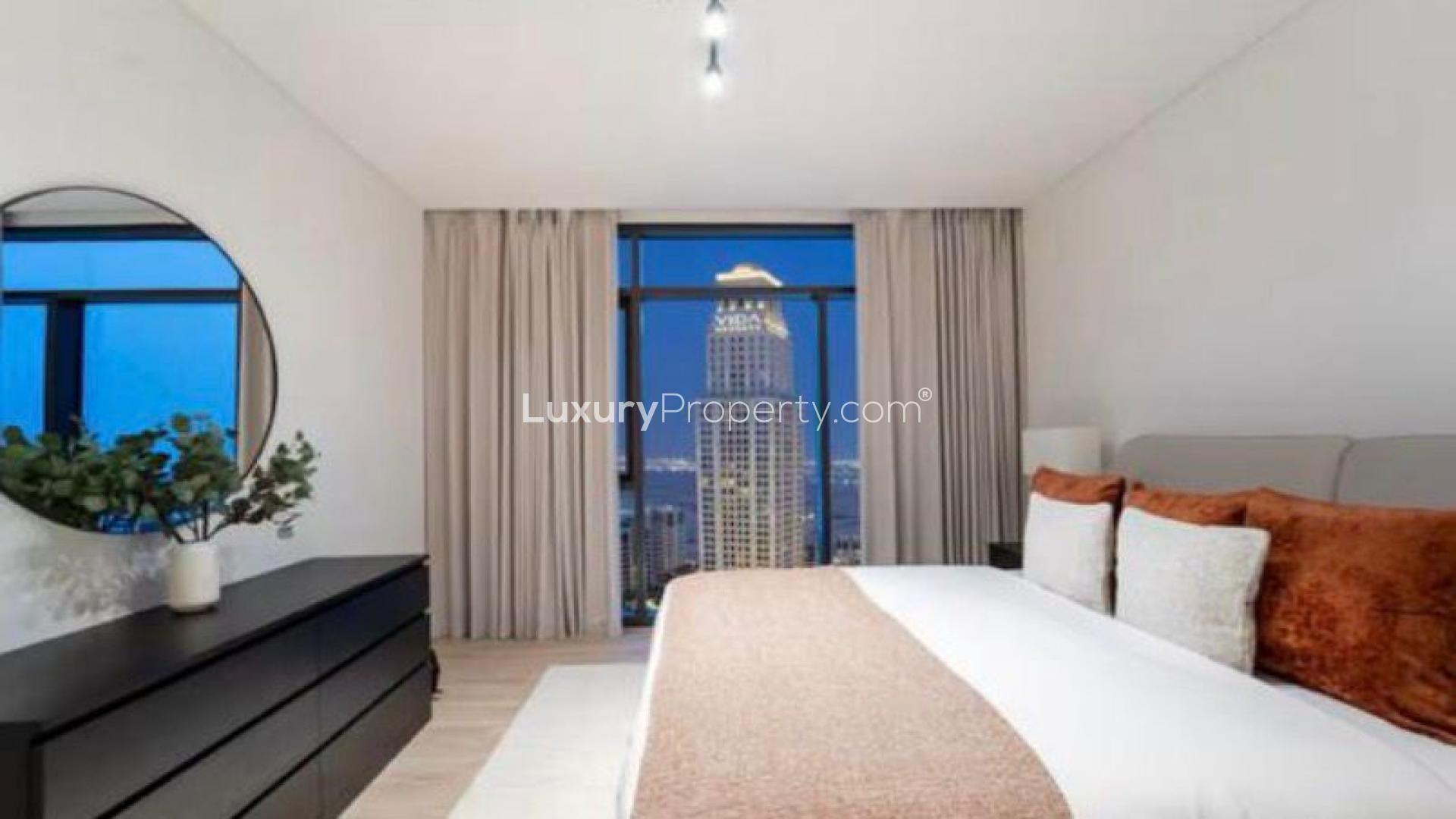 "Modern living room in Dubai Creek Harbour apartment, Palace Residences, with city view.",Modern bedroom in Dubai Creek Harbour apartment with city view through large window