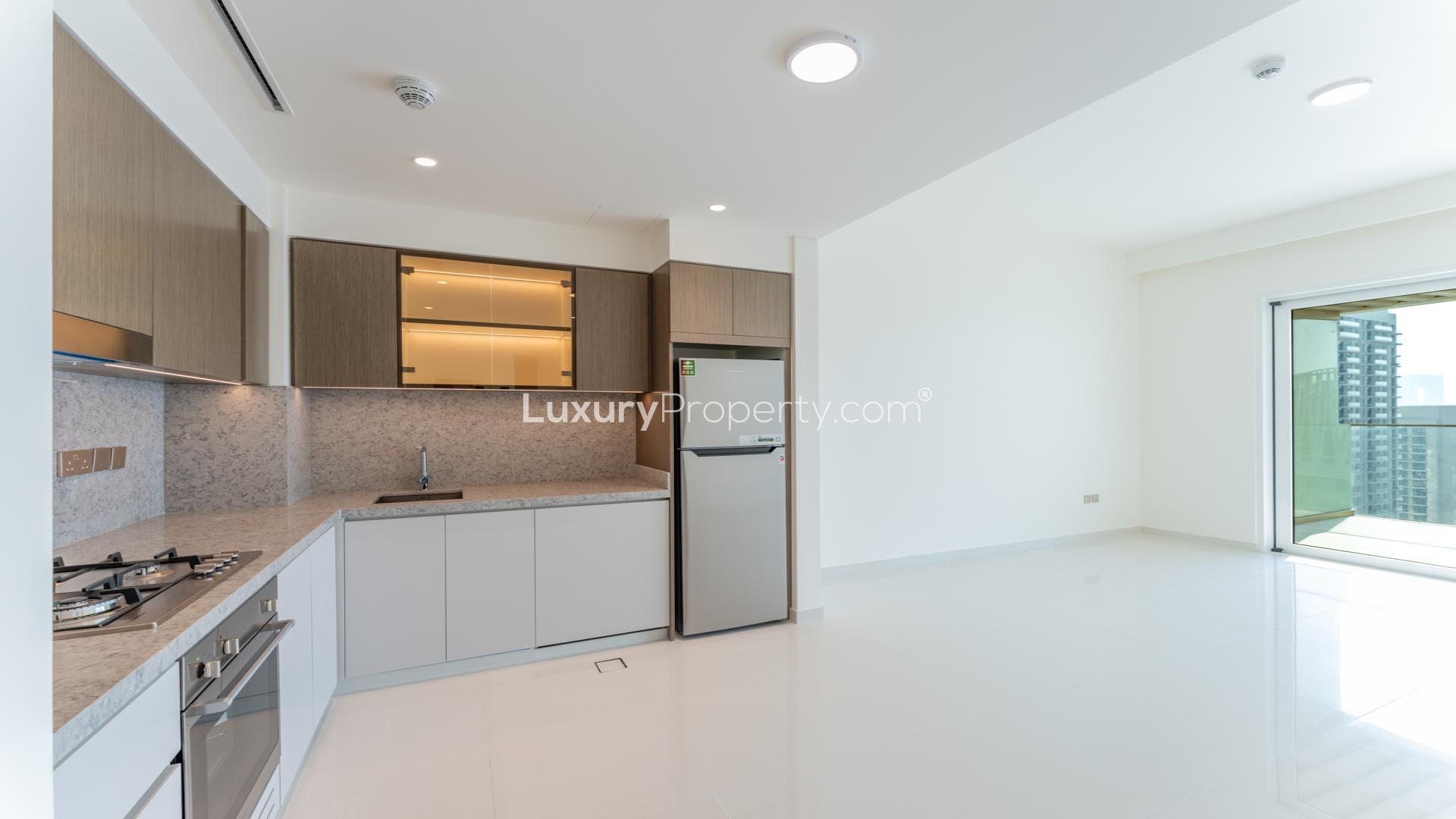 Beachfront apartment exterior at Emaar Beachfront, Dubai Harbour, with palm tree view