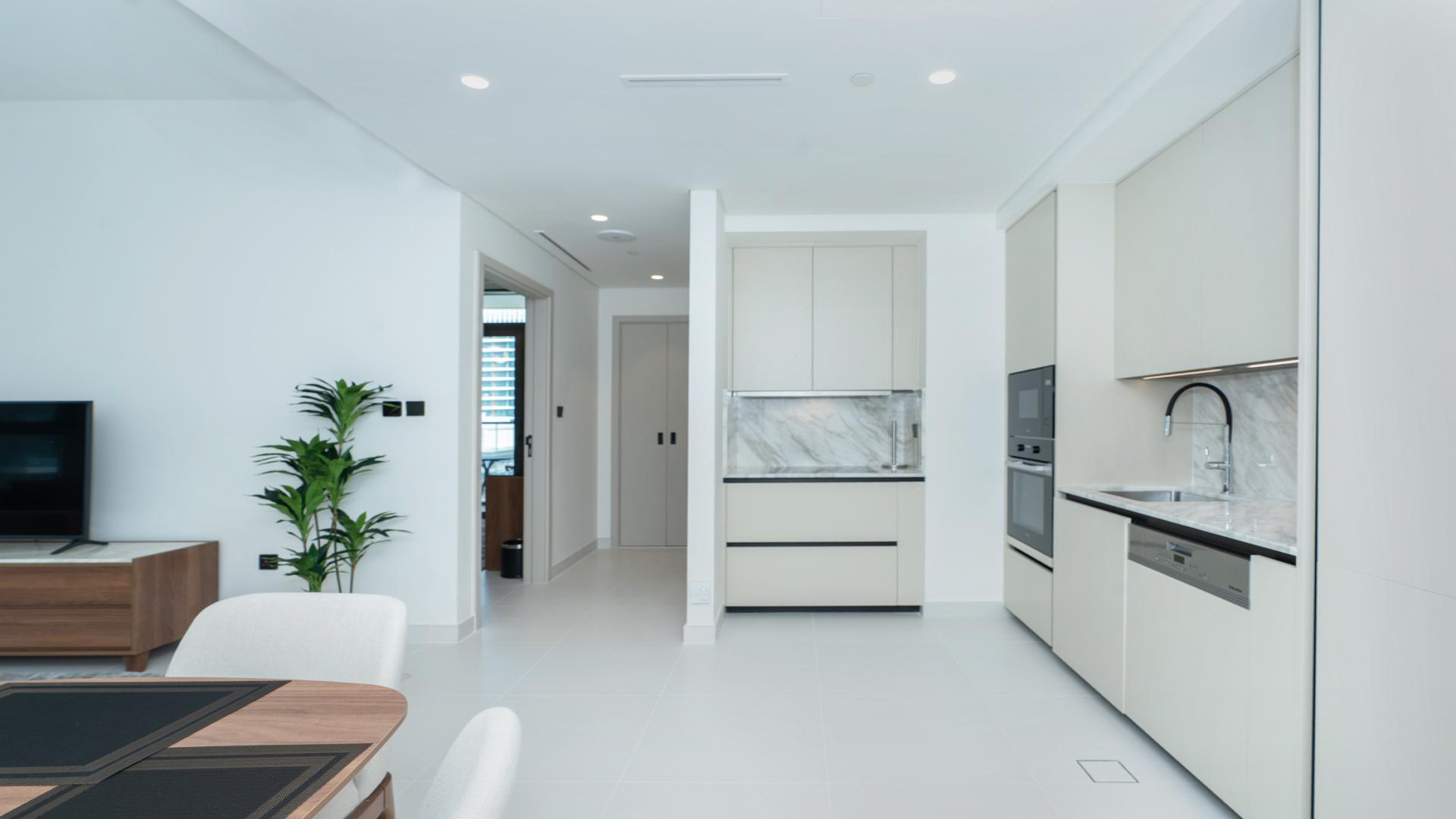 Modern living room and dining area in Emaar Beachfront apartment, Dubai Harbour