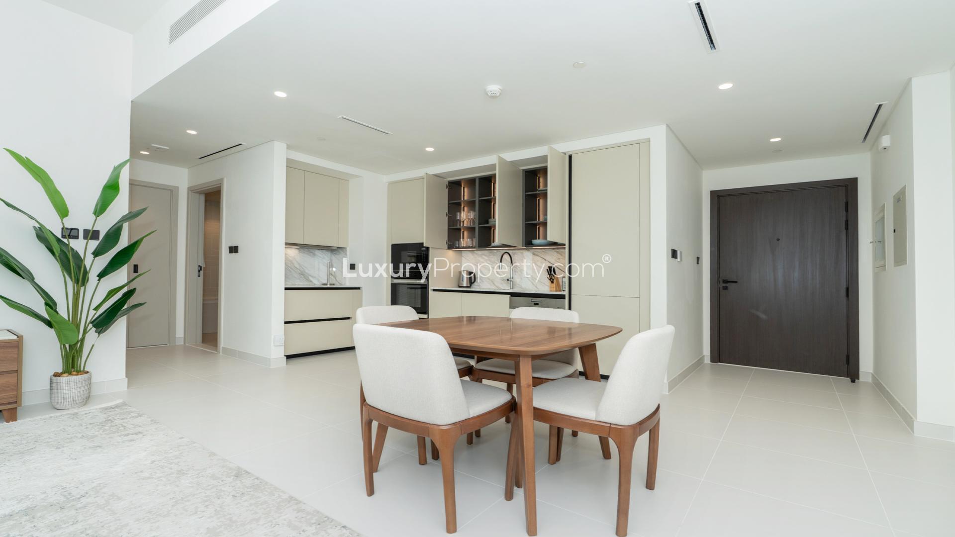 Modern living room with Italian kitchen in Emaar Beachfront apartment, Dubai Harbour