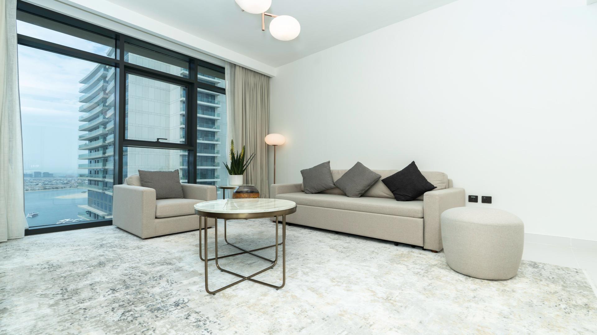 Modern living room in Emaar Beachfront apartment, Dubai Harbour, with sea view and stylish decor