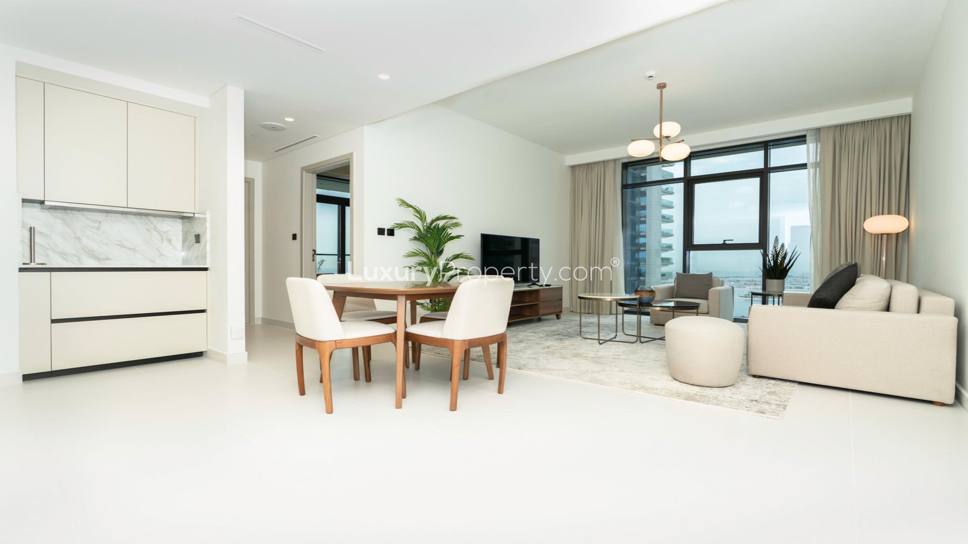 Modern living room in Emaar Beachfront apartment, Dubai Harbour, with large windows and stylish decor