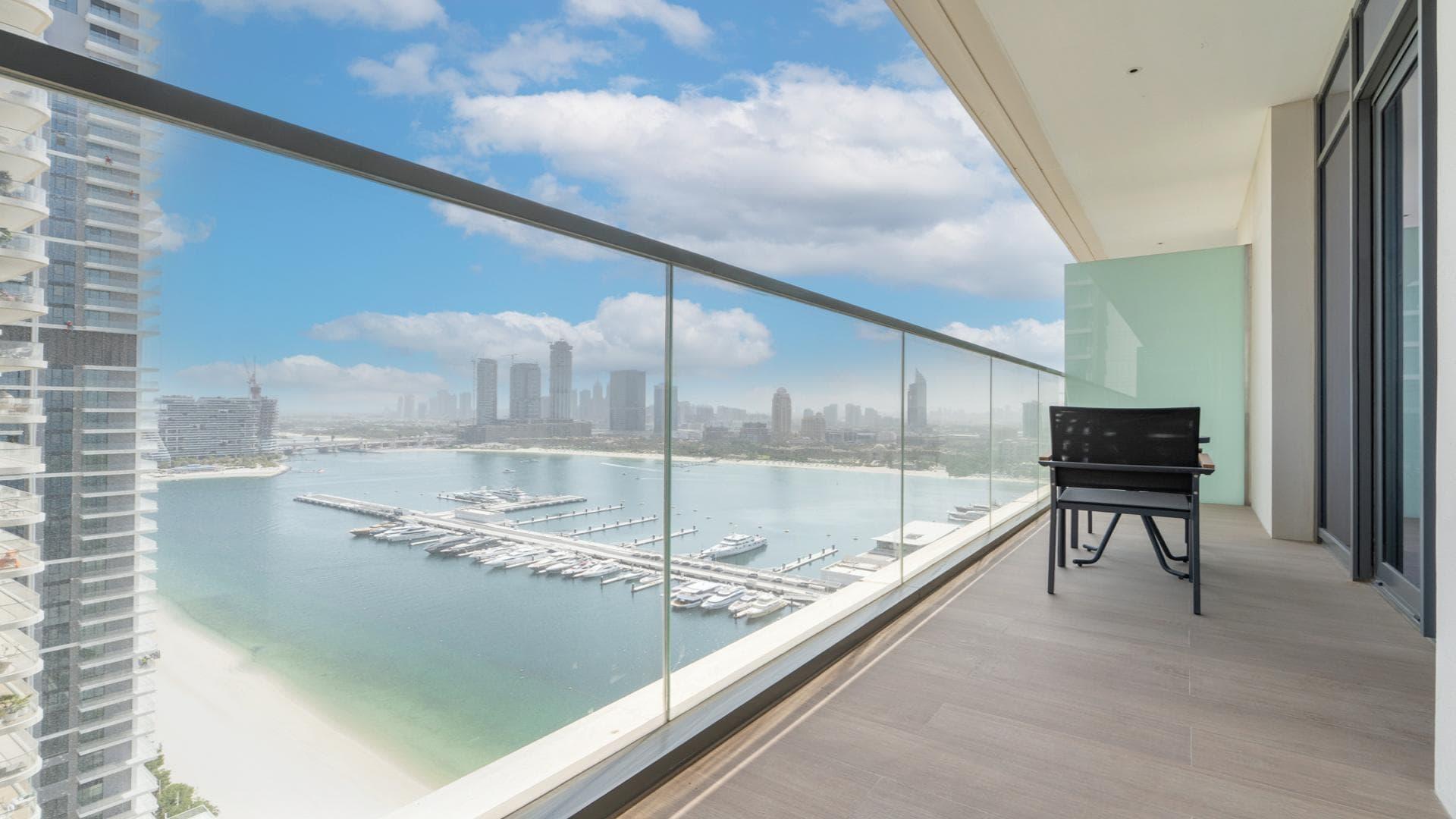 High-floor apartment balcony view of marina and skyline at Emaar Beachfront, Dubai Harbour
