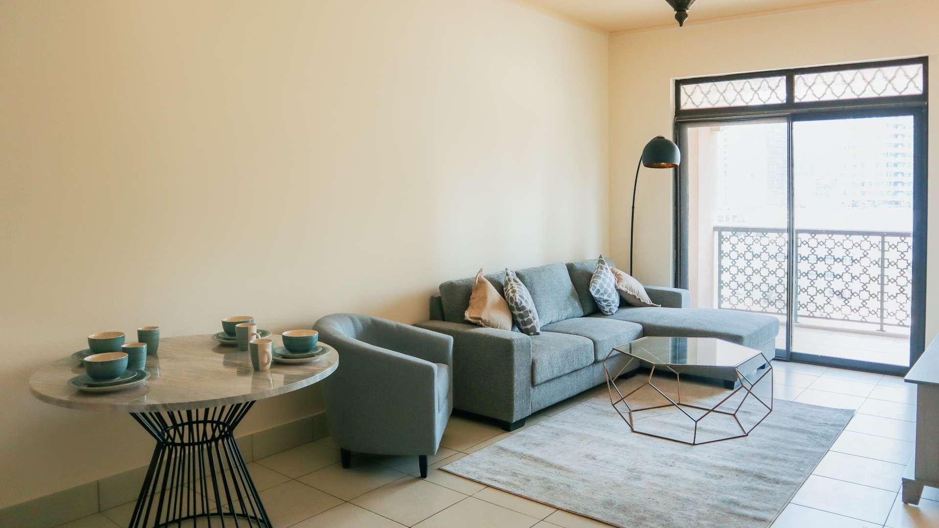 "Balcony view from Reehan apartment overlooking Old Town skyline, available for rent.",Spacious Reehan apartment living room with modern decor, Old Town view balcony