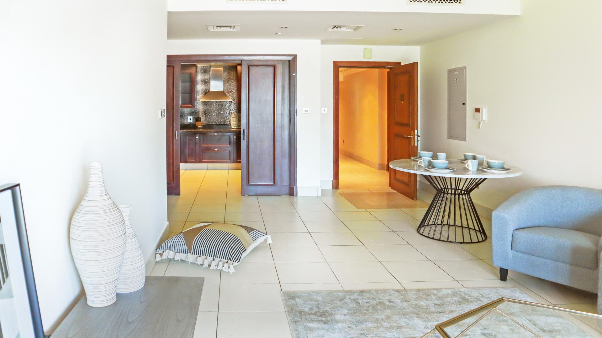 "Modern Reehan apartment interior with open kitchen, dining area, and cozy seating in Old Town.",Bright bedroom in Reehan apartment, Old Town, featuring modern furniture and ample natural light