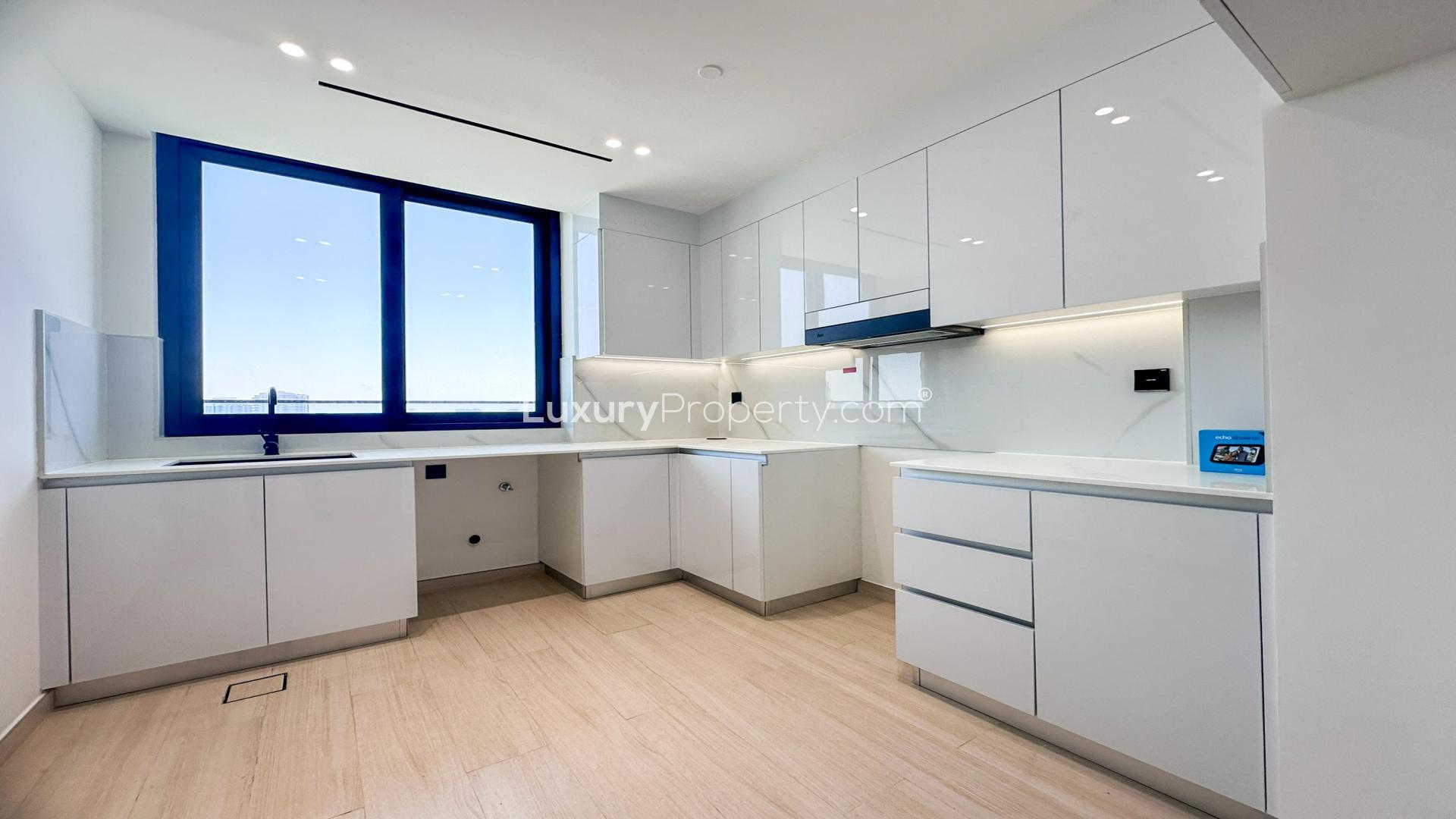 Empty room with large window, high floor view in Jumeirah Village Circle apartment