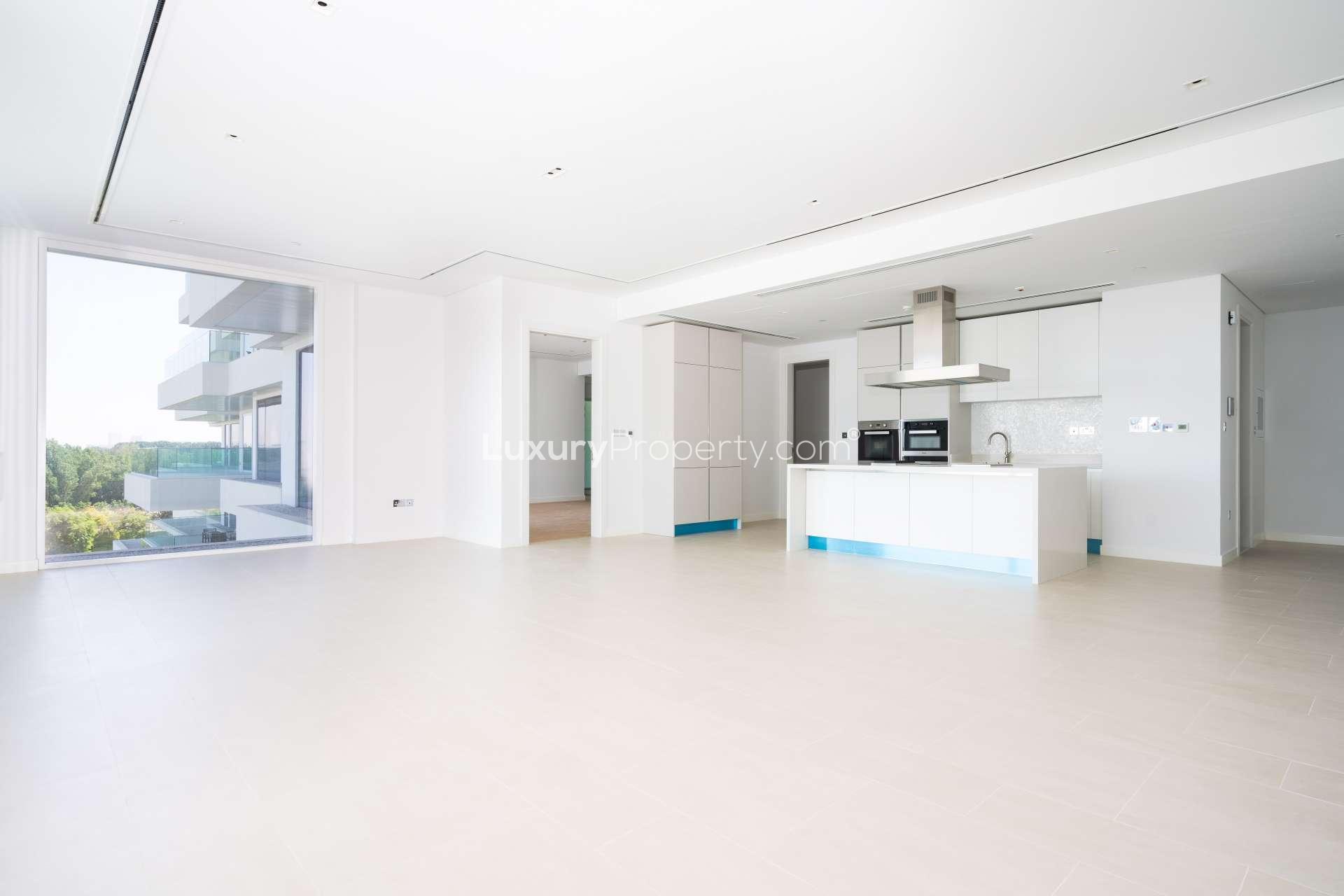 "Spacious balcony view from 1-bedroom apartment in Seventh Heaven, Al Barari, for rent.",Modern kitchen and living area in Seventh Heaven, Al Barari apartment for rent