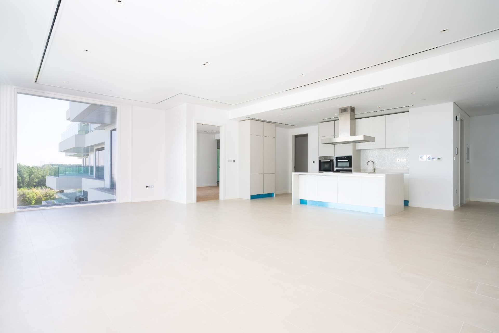 "Spacious balcony view from 1-bedroom apartment in Seventh Heaven, Al Barari, for rent.",Modern kitchen and living area in Seventh Heaven, Al Barari apartment for rent