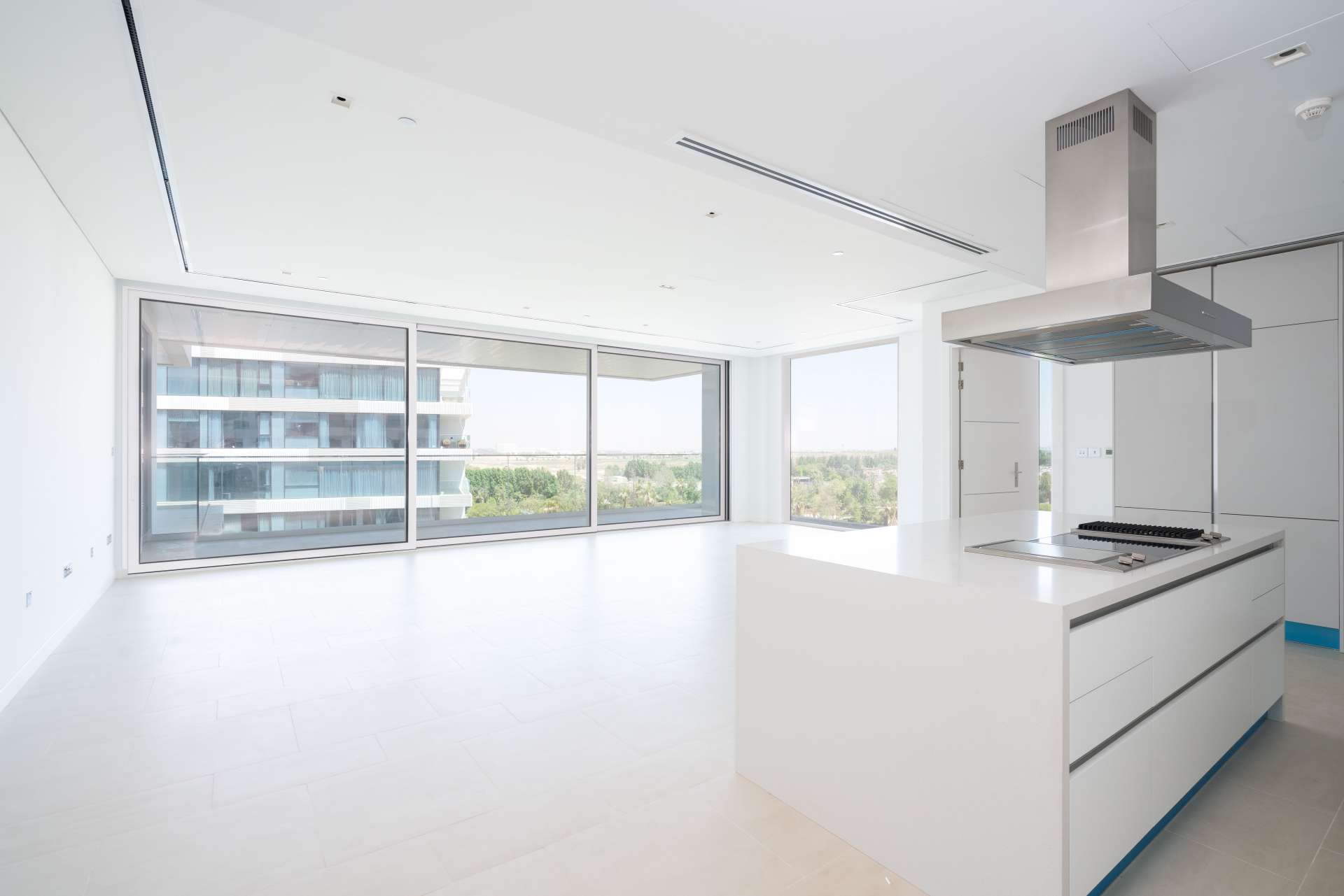 Modern 1-bedroom apartment exterior in Seventh Heaven, Al Barari, with glass balconies