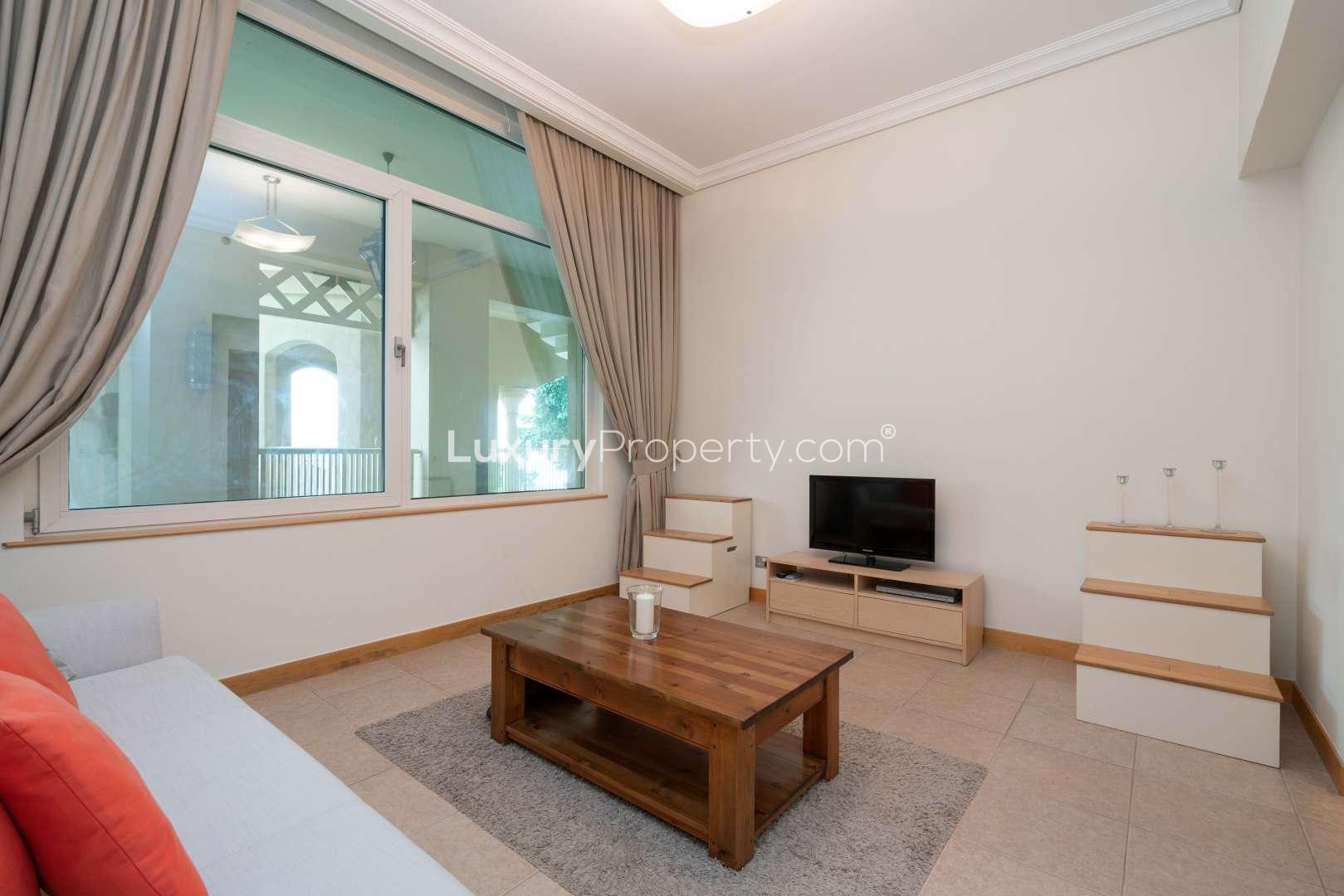 Fully furnished living room in Shoreline Apartments, Palm Jumeirah with modern decor and large window