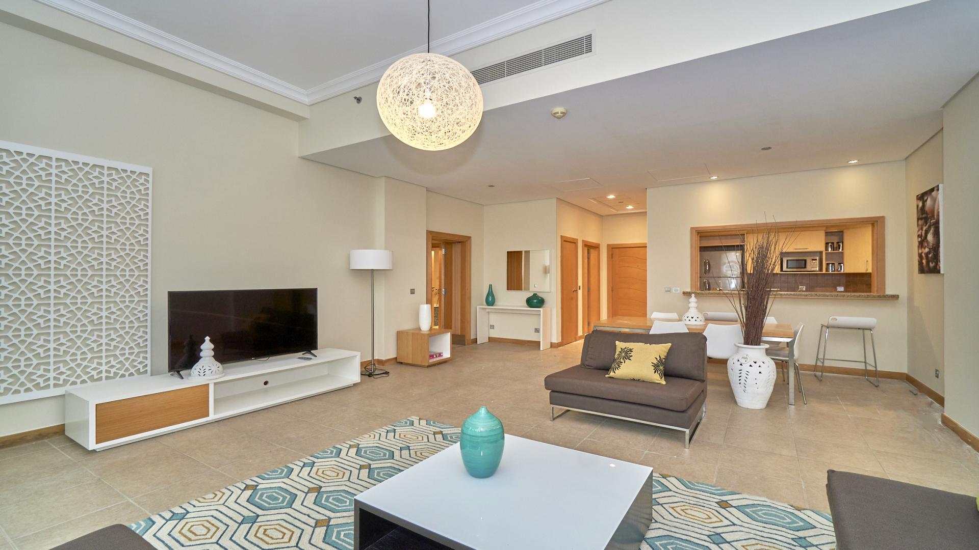 Furnished living room in Shoreline Apartment, Palm Jumeirah with modern decor and balcony view
