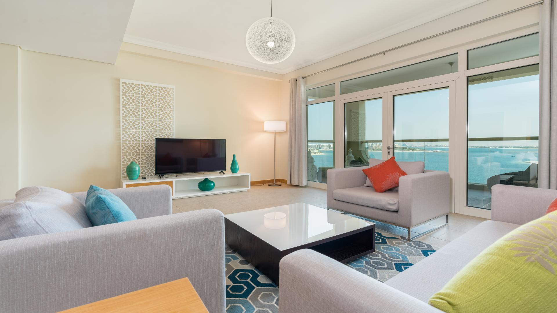 Fully furnished living room in Palm Jumeirah apartment with beach view, modern decor