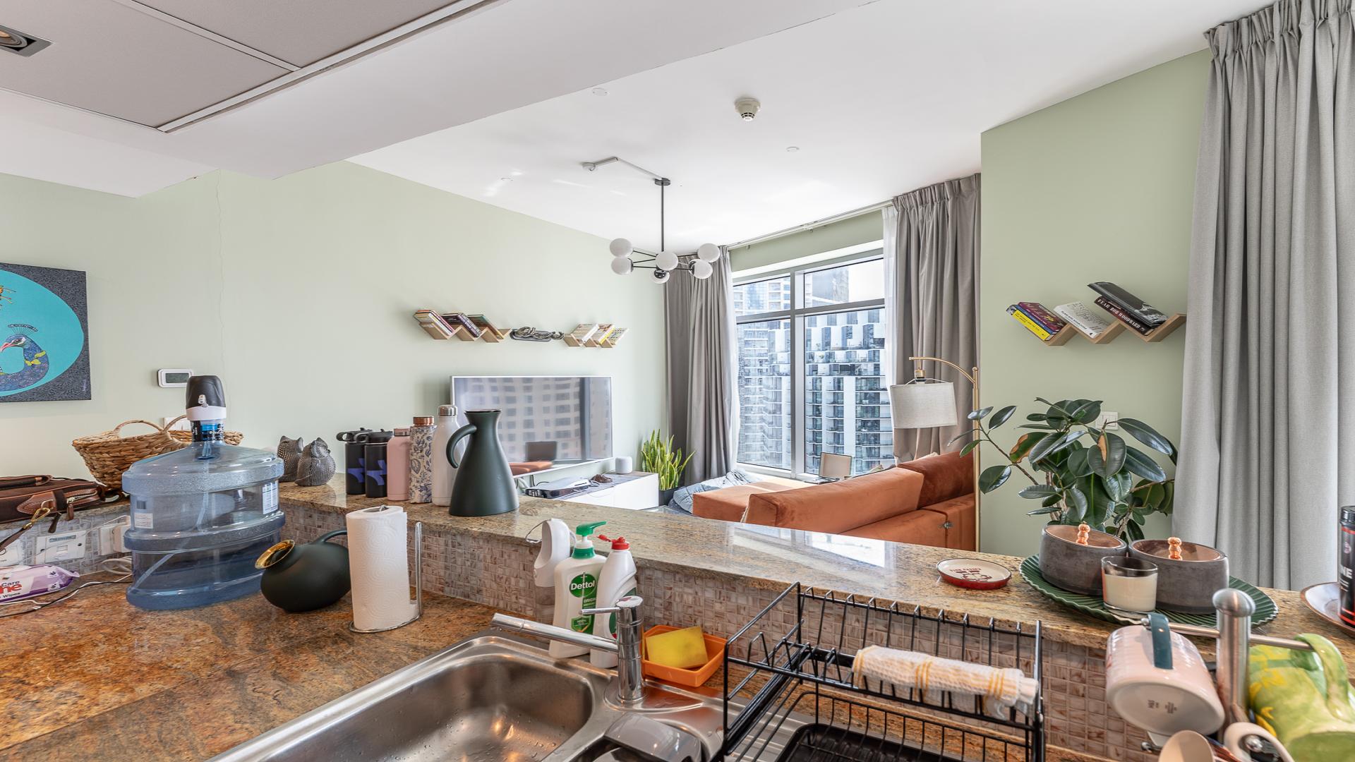 Furnished Dubai Marina apartment kitchen and dining area with modern decor and large windows