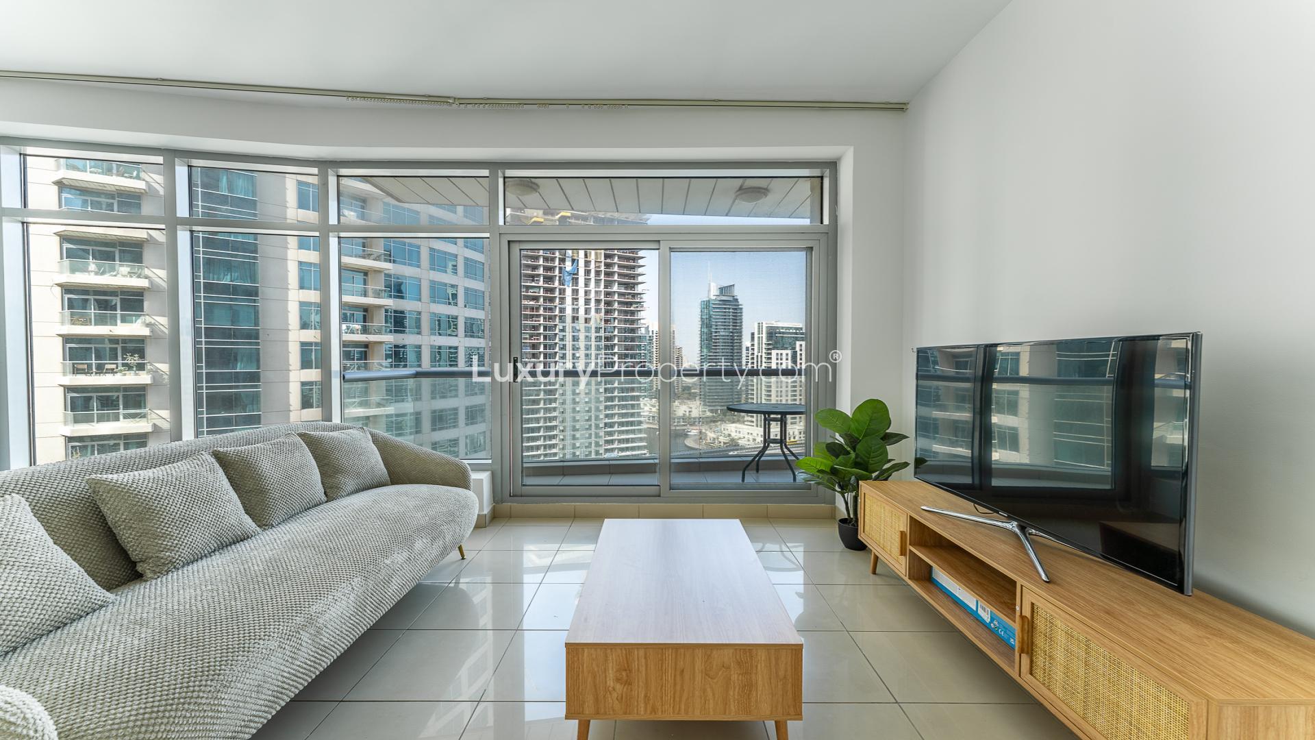 Fully furnished high-floor apartment living room with Dubai Marina skyline view in Park Island