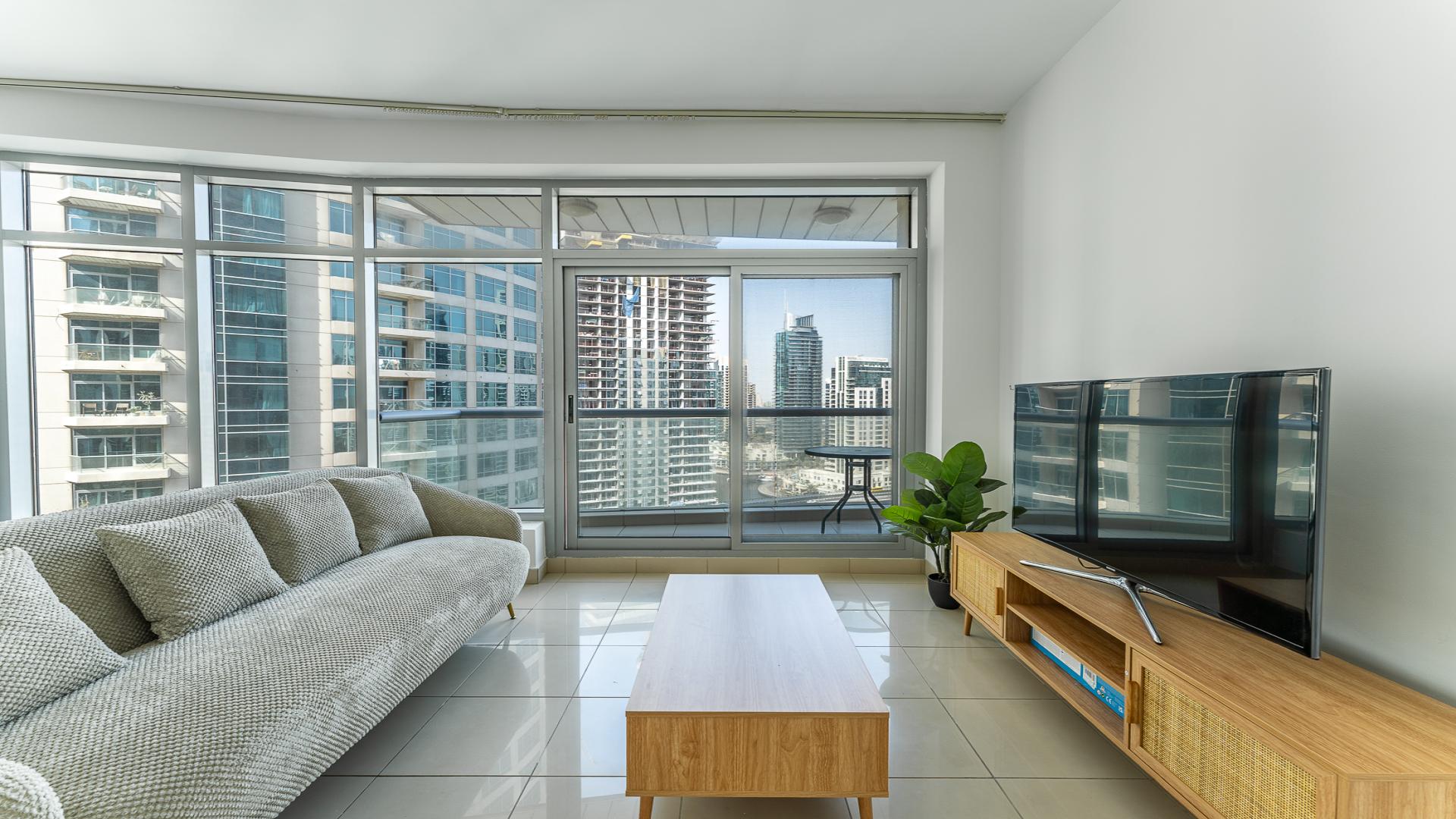 Fully furnished high-floor apartment living room with Dubai Marina skyline view in Park Island