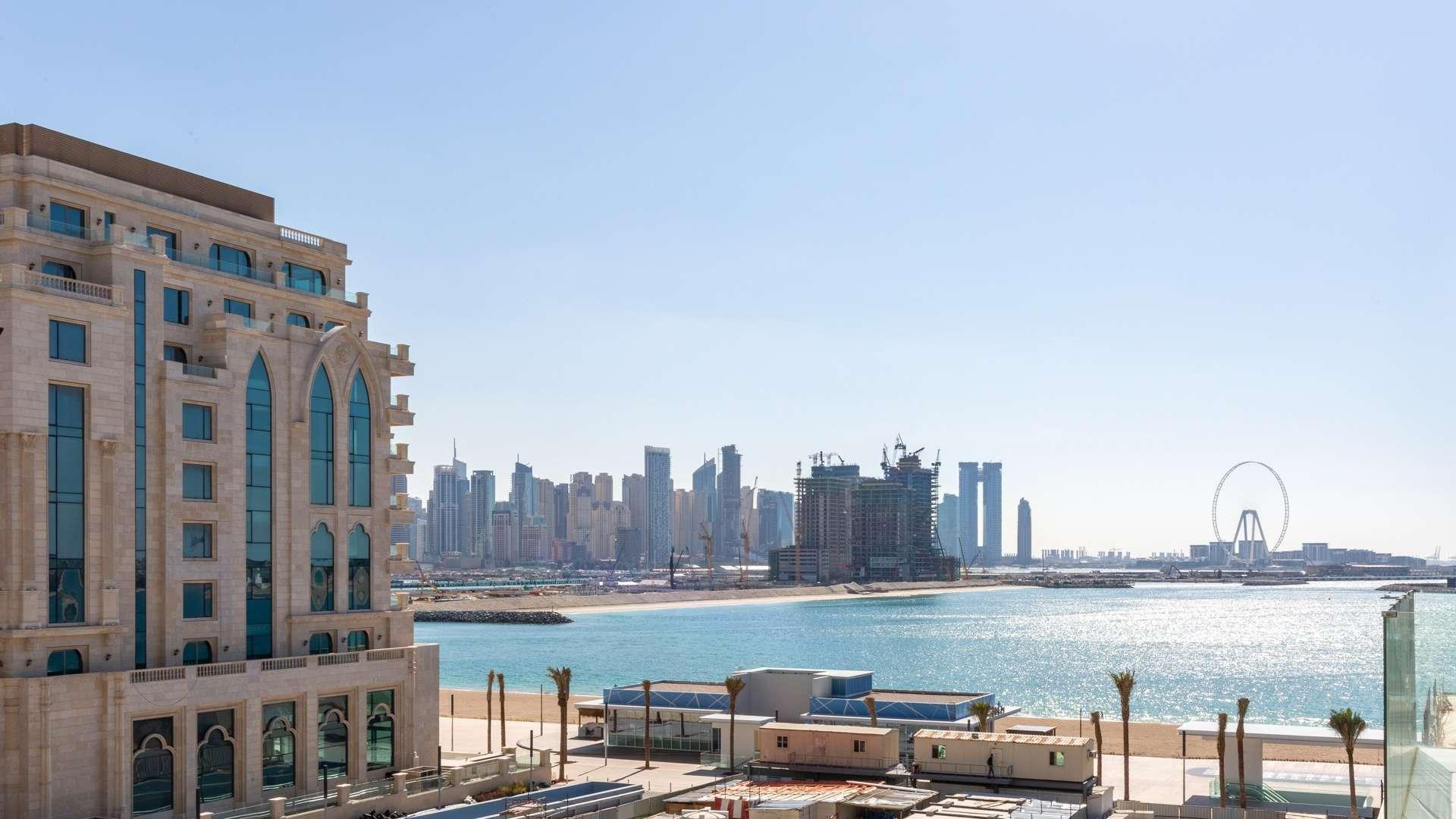 Furnished living room in Soho Palm Jumeirah apartment with modern decor and natural light