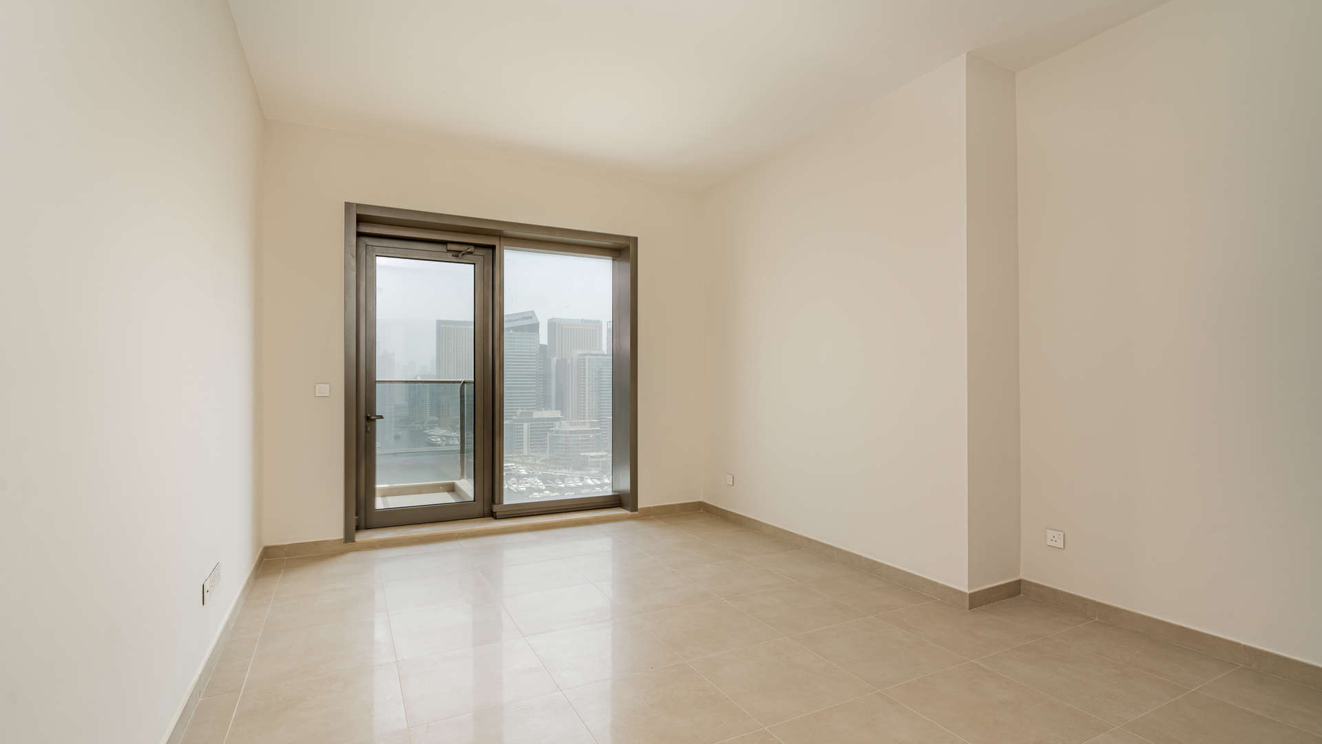 Empty room with large window, marina view in Sparkle Towers, Dubai Marina apartment for rent