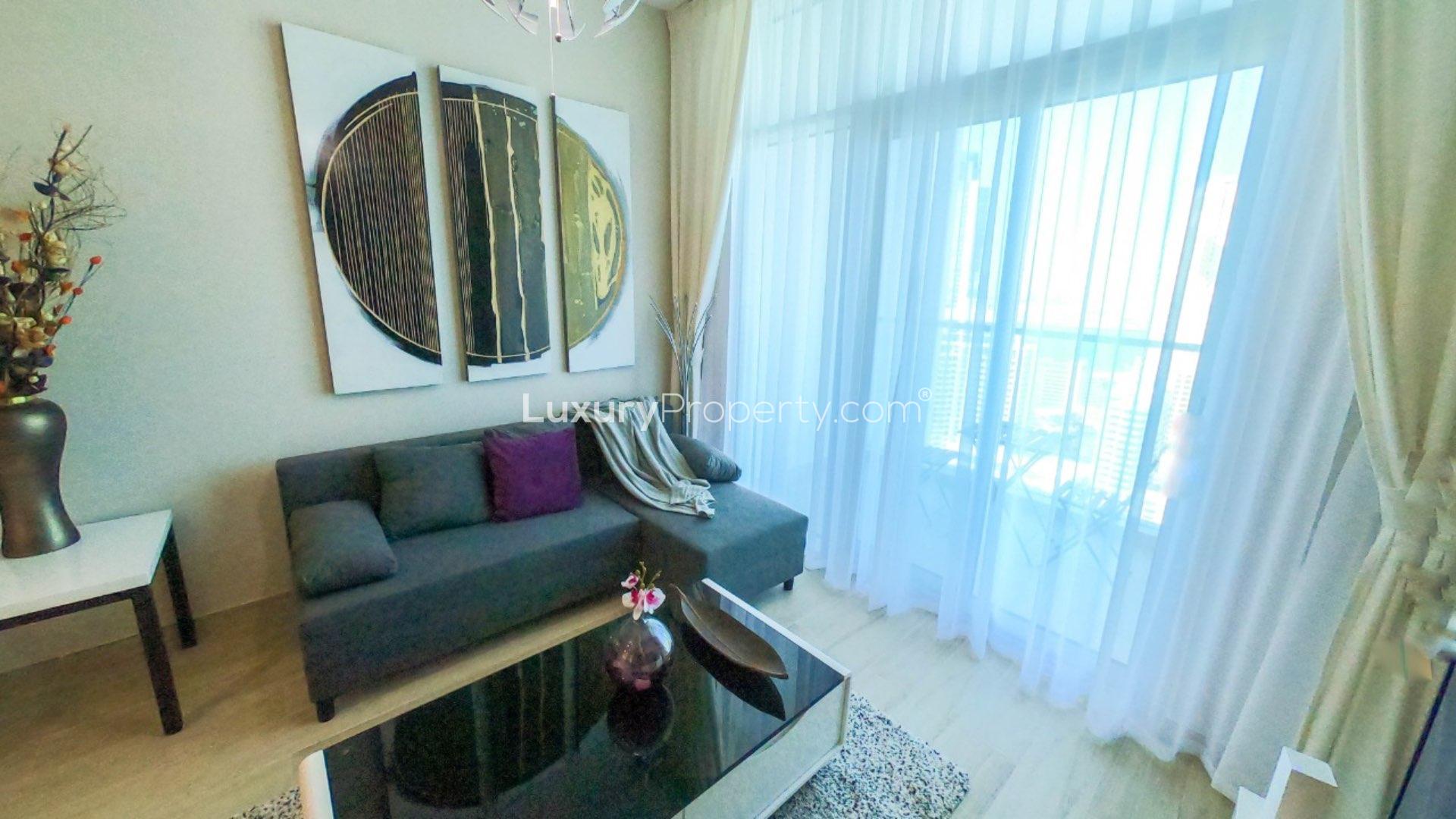 Modern living room in Dubai Marina apartment with large TV and stylish decor