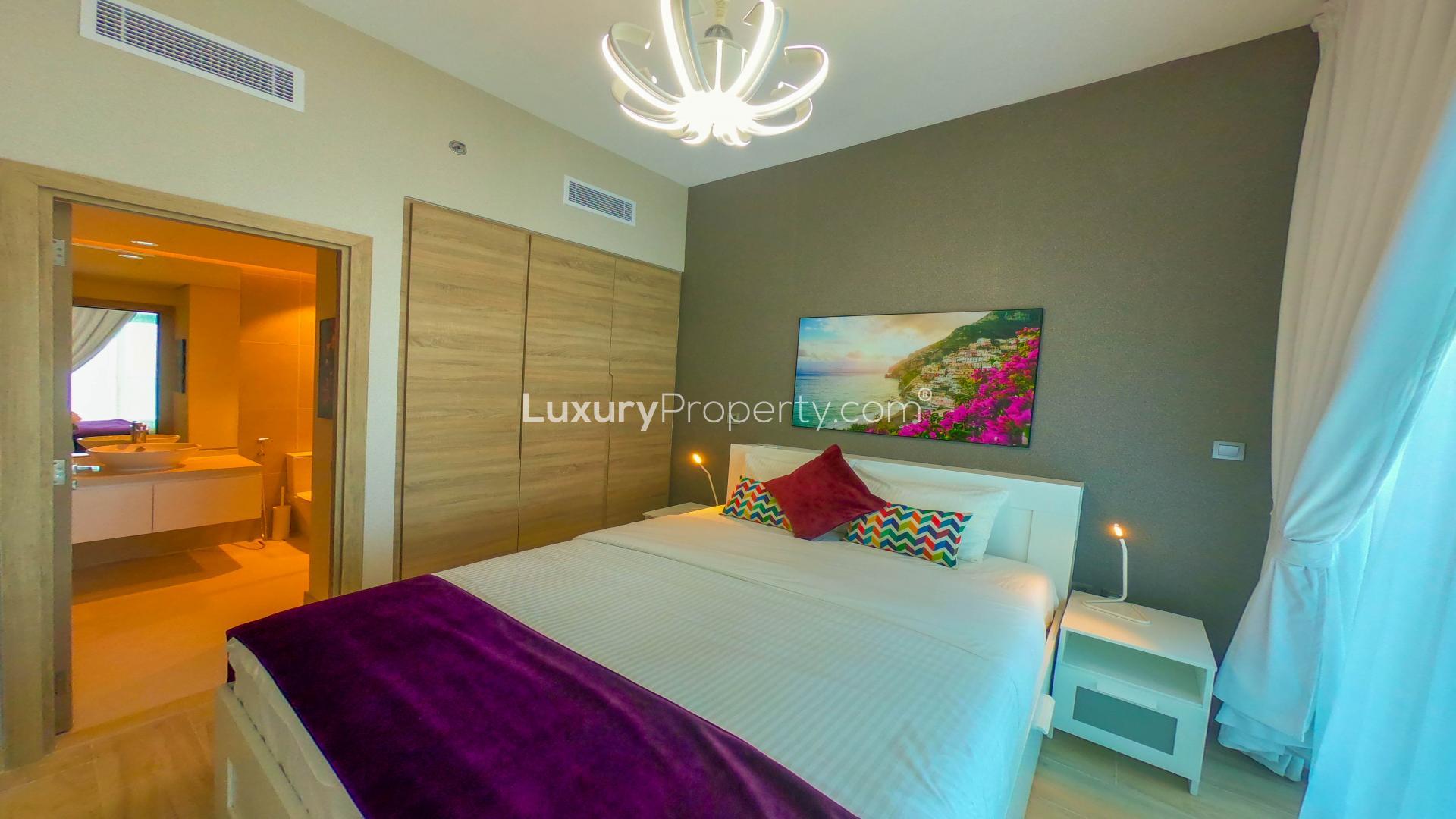 Luxurious bedroom in Dubai Marina apartment with sea view, modern decor, vibrant accents