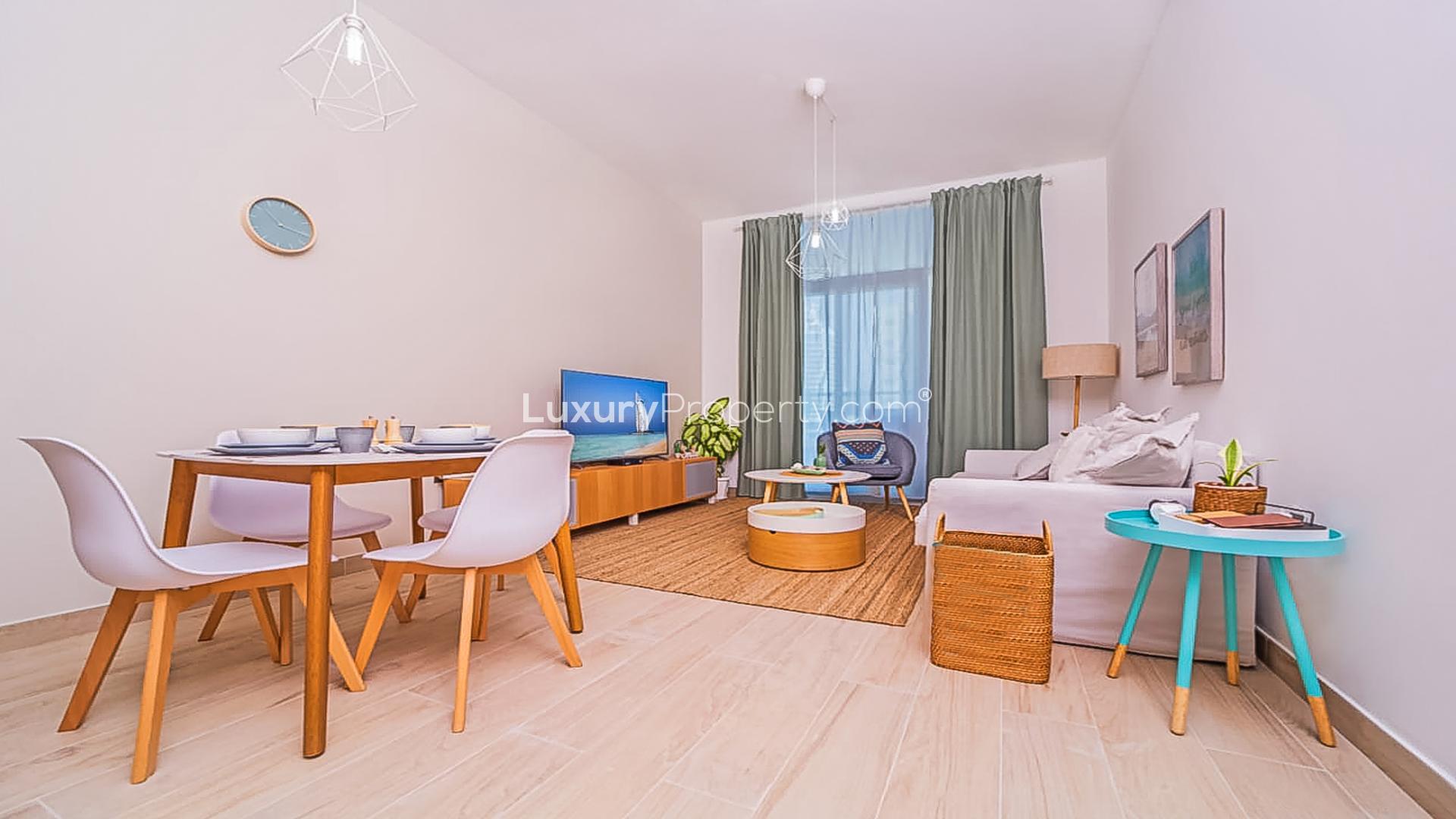 Modern living room in Studio One apartment, Dubai Marina with cozy decor and natural light