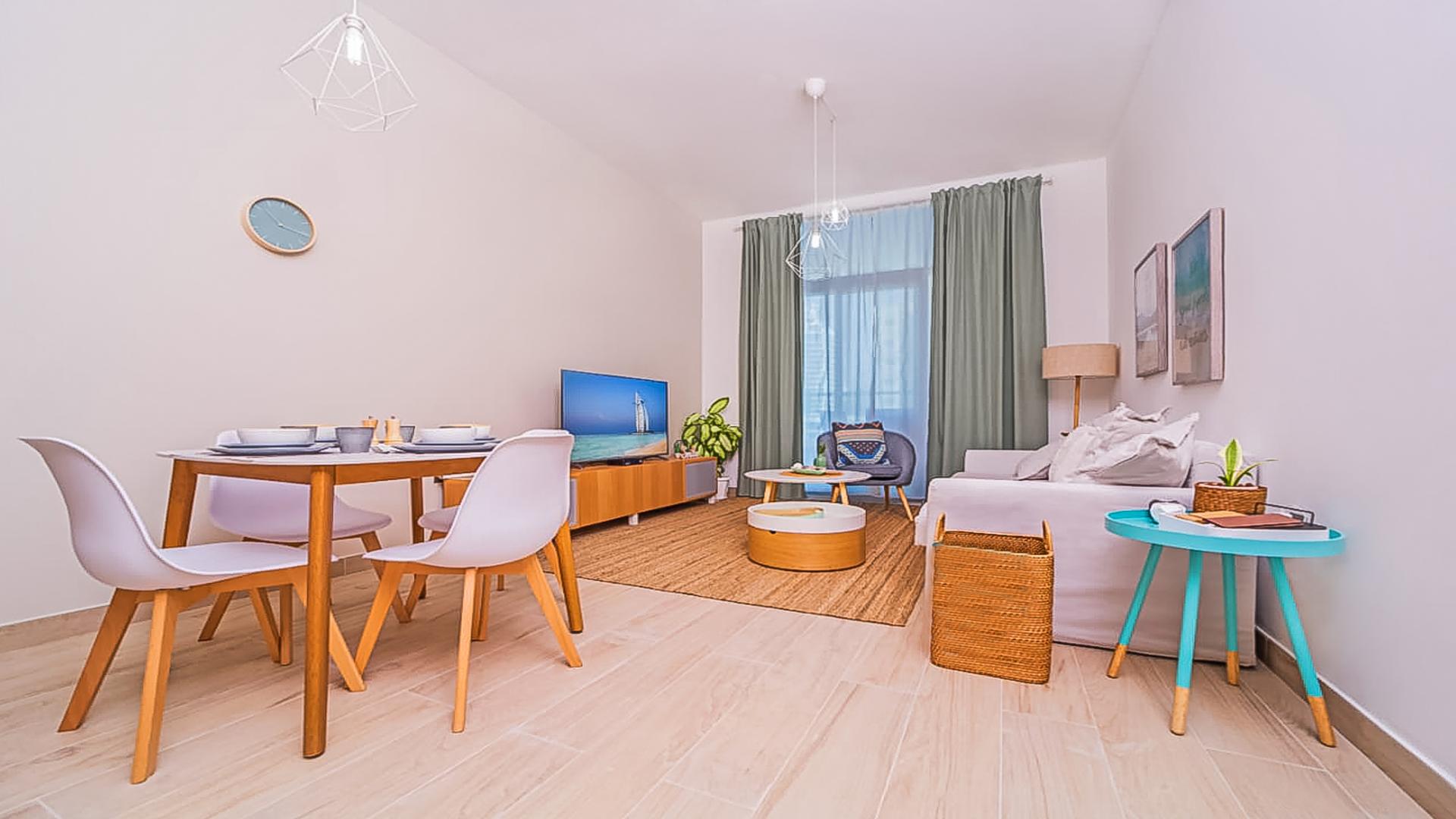 Modern living room in Studio One apartment, Dubai Marina with cozy decor and natural light