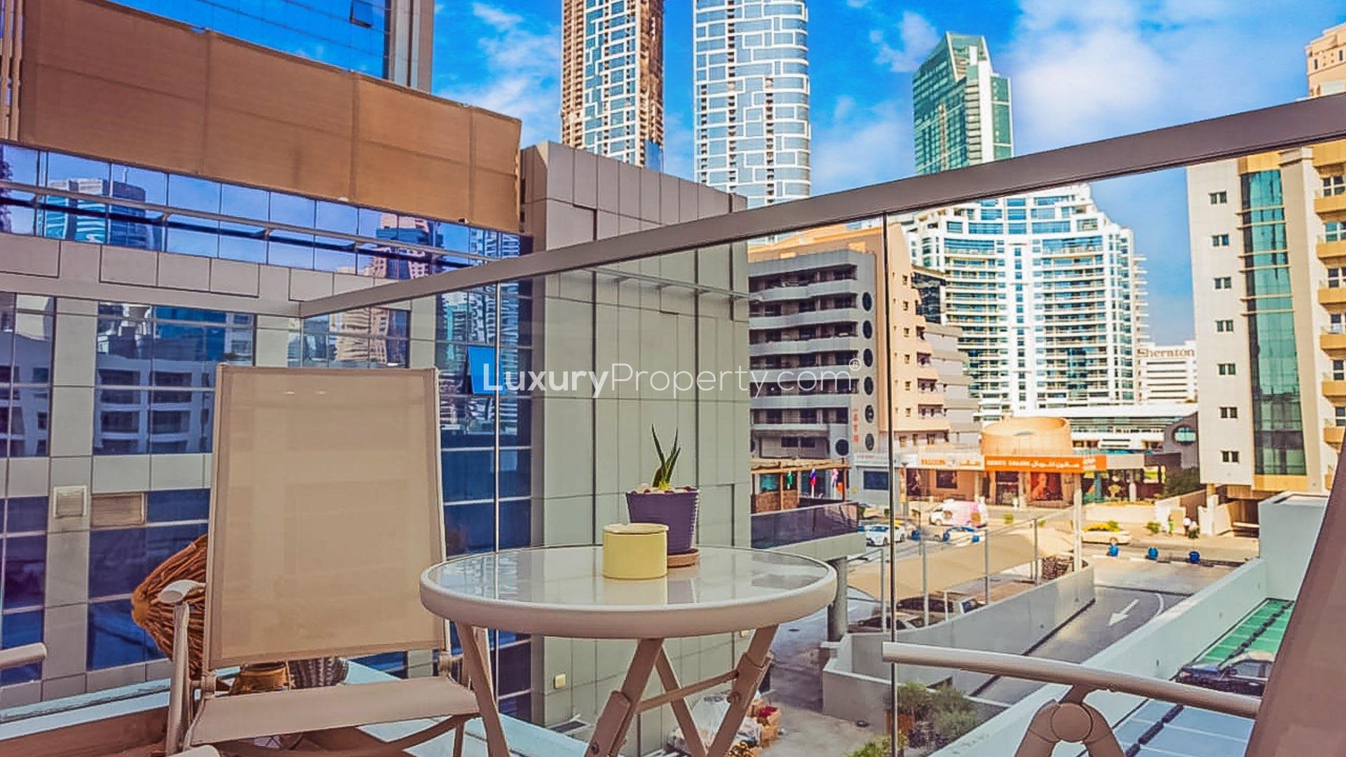 Modern living room in Studio One apartment, Dubai Marina, featuring stylish decor and dining area