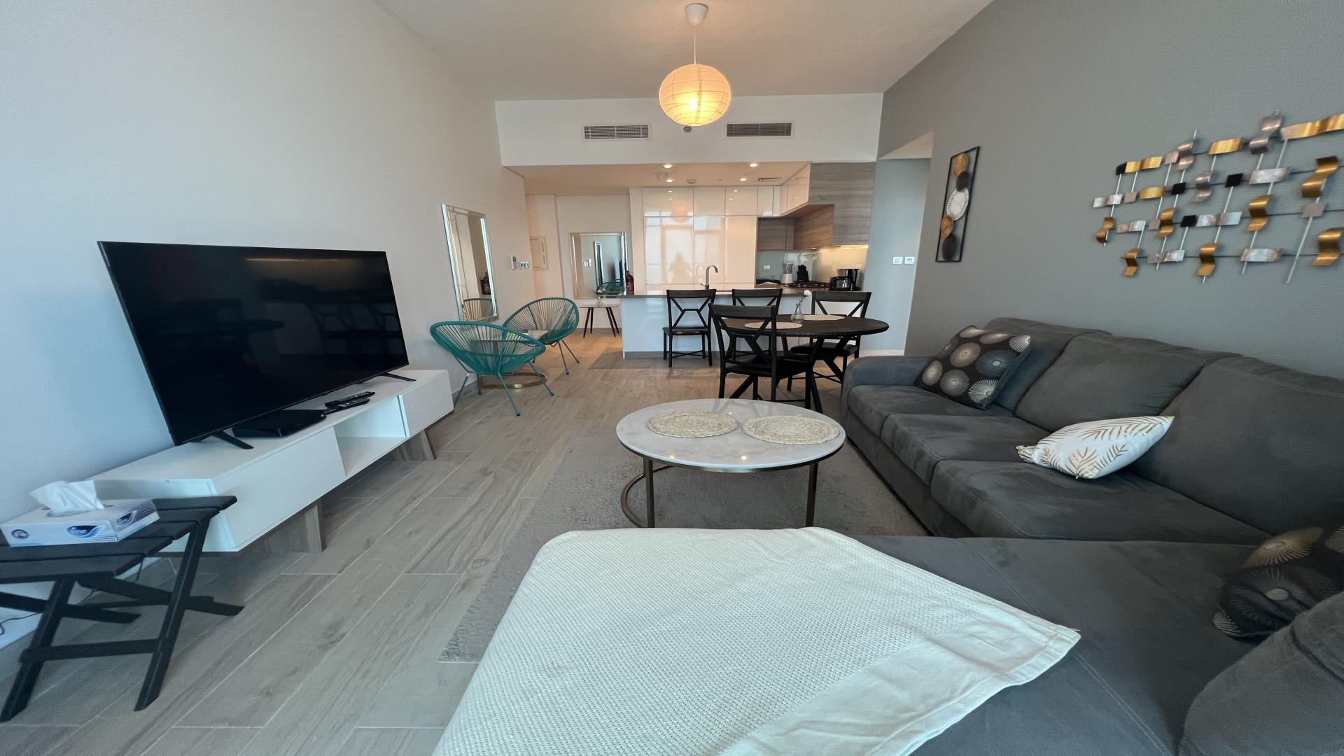 Modern furnished living room in one-bedroom apartment, Studio One, Dubai Marina with balcony view