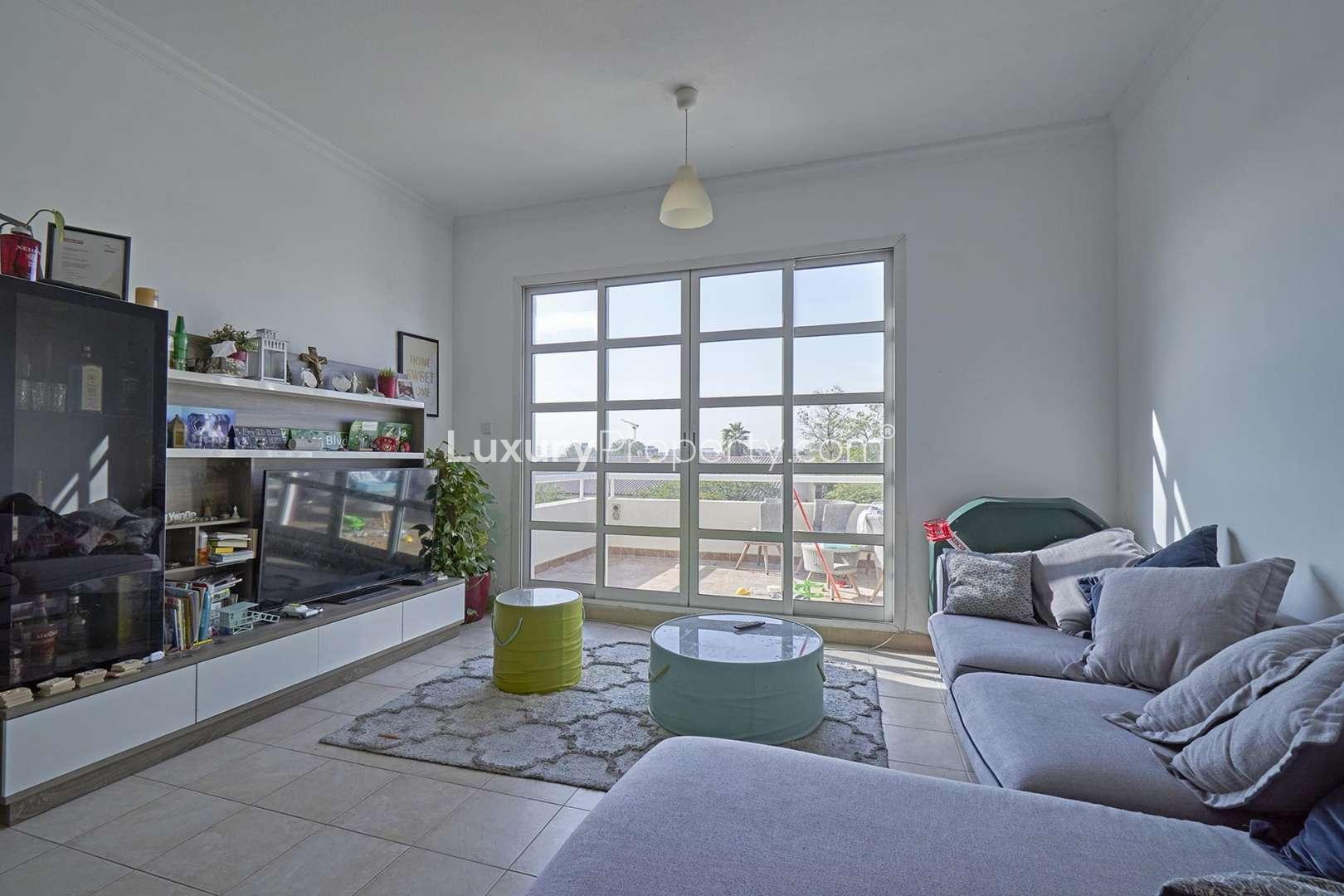 Bright living room with large windows in Green Community East lakeside apartment
