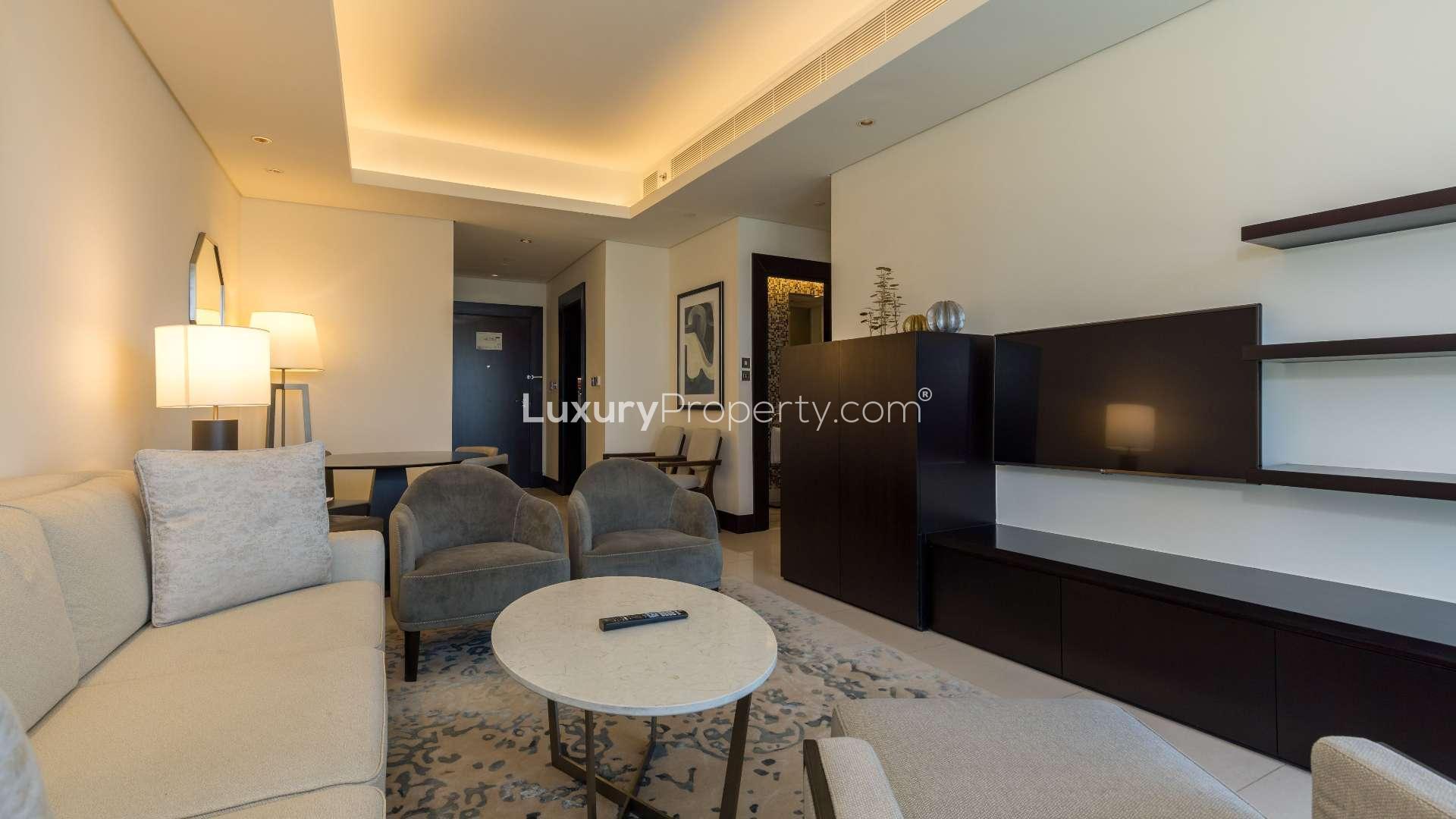 Fully furnished living room in Downtown Dubai apartment, modern decor, comfortable seating arrangement