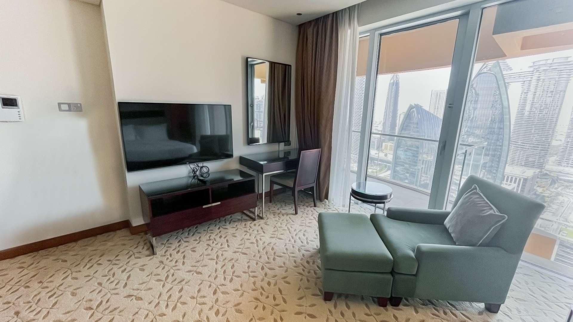 Balcony view from luxury studio apartment overlooking Downtown Dubai skyline at The Address Dubai Mall