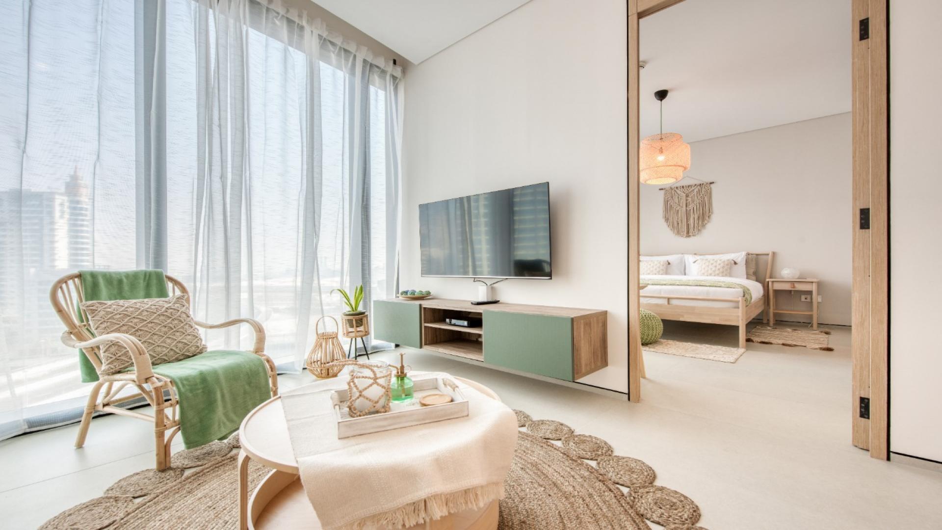 Furnished bedroom in Jumeirah Beach Residence apartment, featuring elegant decor and natural light