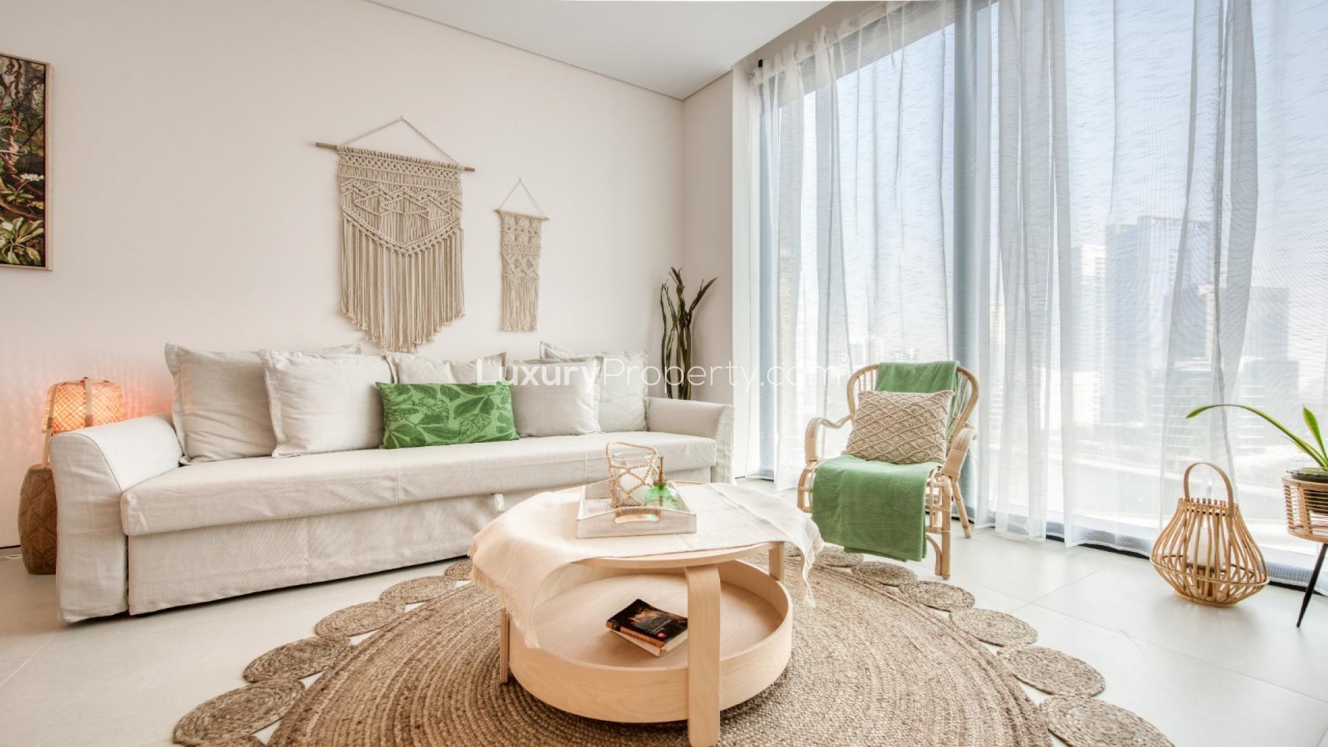 Furnished apartment living area with dining table and marina view at Jumeirah Beach Residence