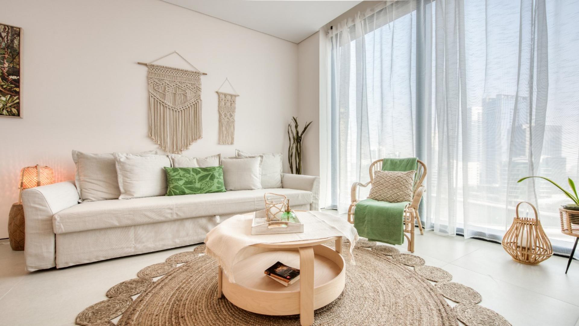 Furnished apartment living area with dining table and marina view at Jumeirah Beach Residence